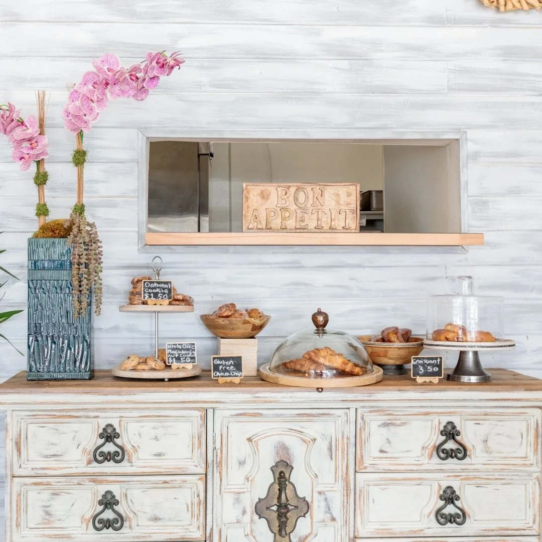 Charming café display with pastries and floral decor