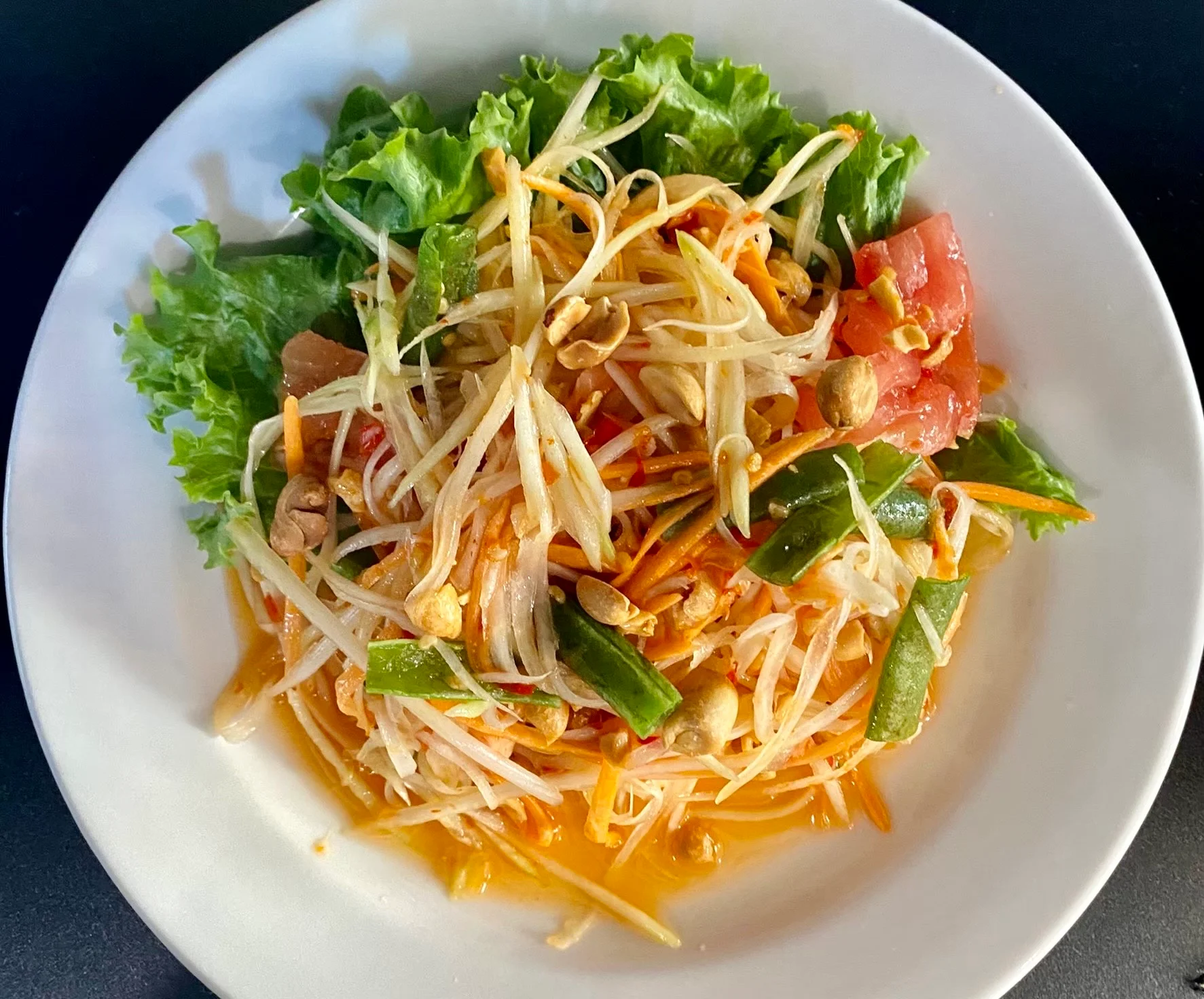 Thai papaya salad served on a bed of lettuce