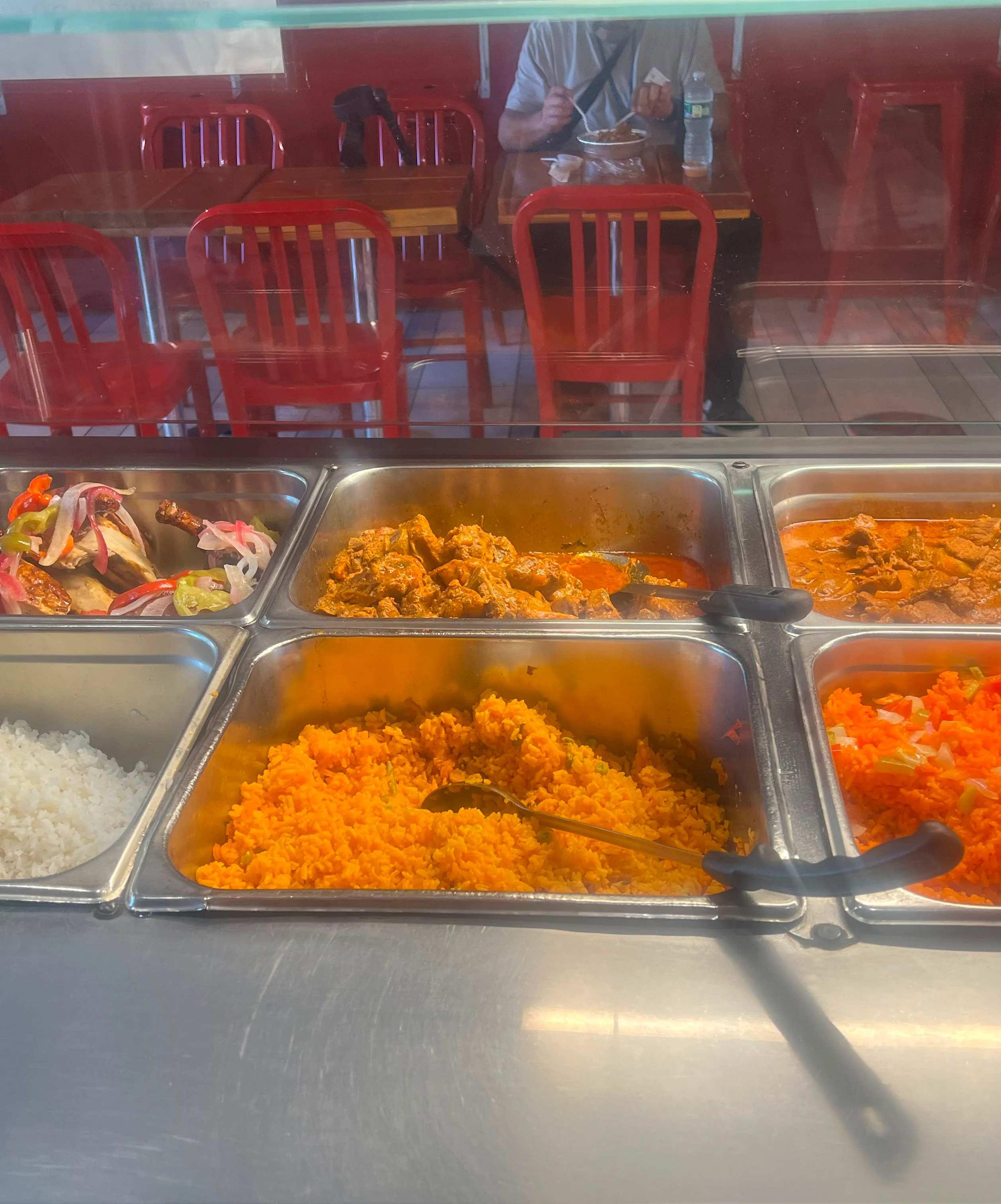 Nigerian jollof rice with assorted meats and sides