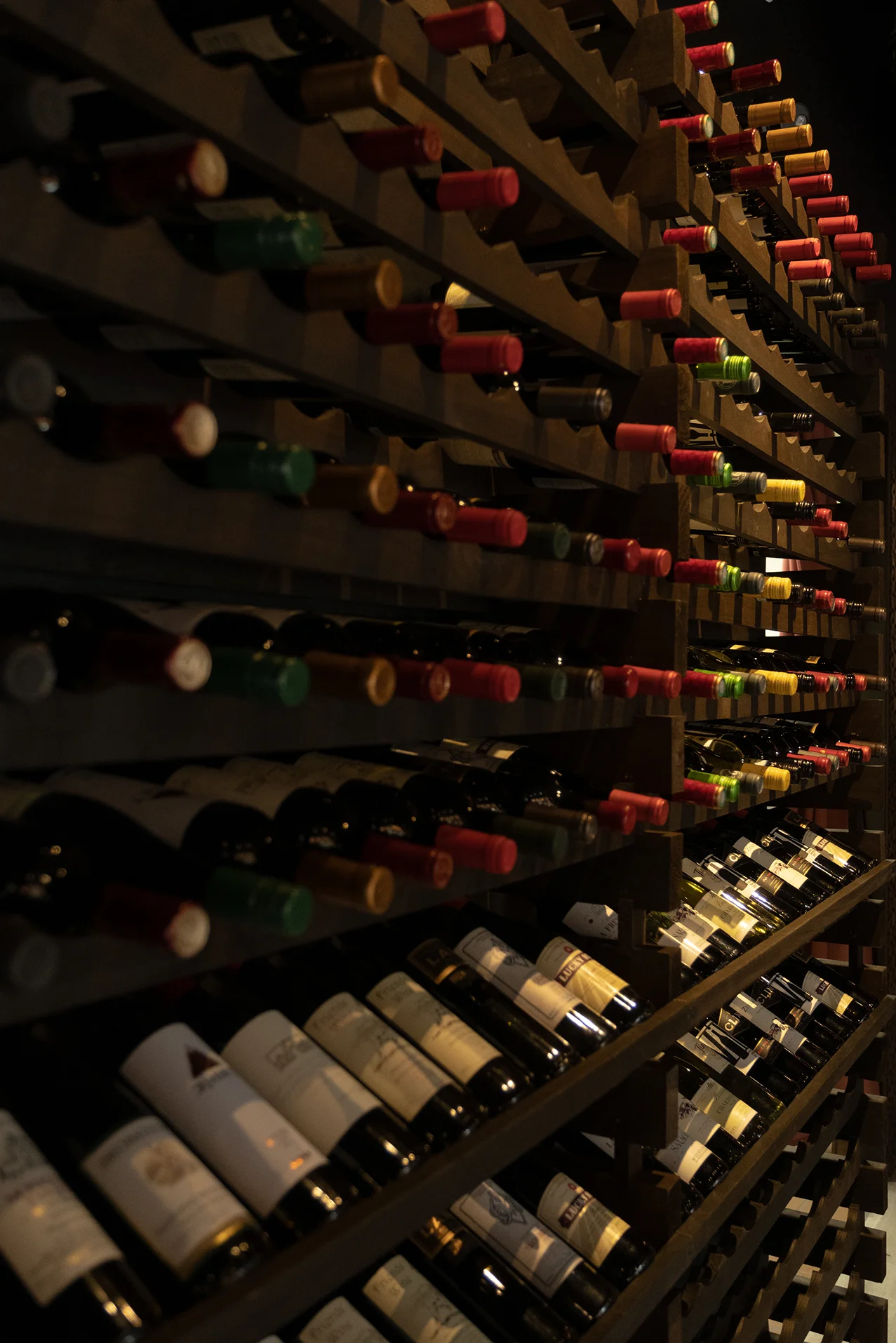 Wine rack displaying a variety of bottles in a cozy restaurant