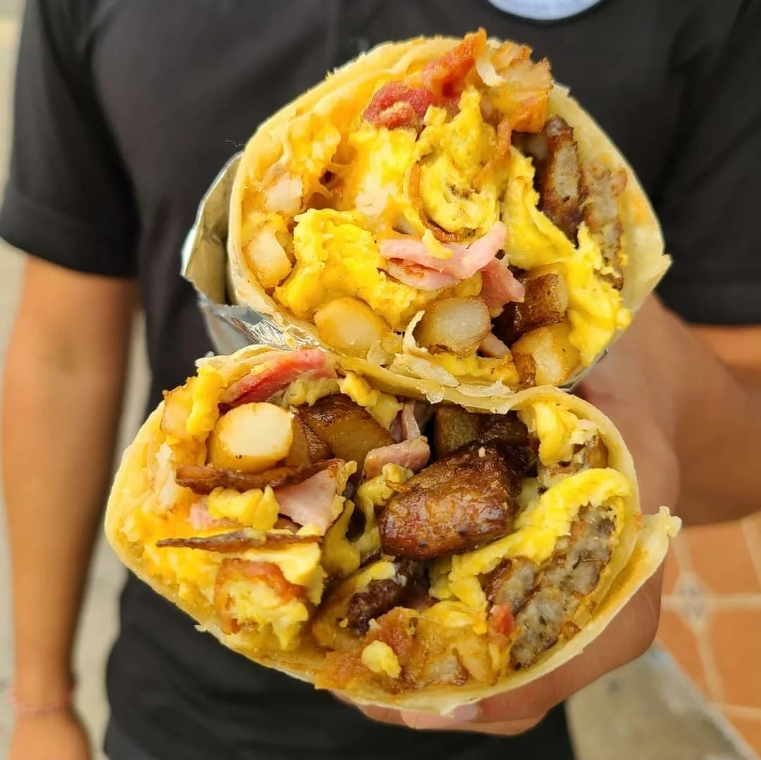 Delicious breakfast burrito filled with eggs and meats
