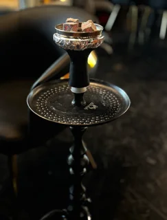 Elegant hookah setup with coals on a decorative tray