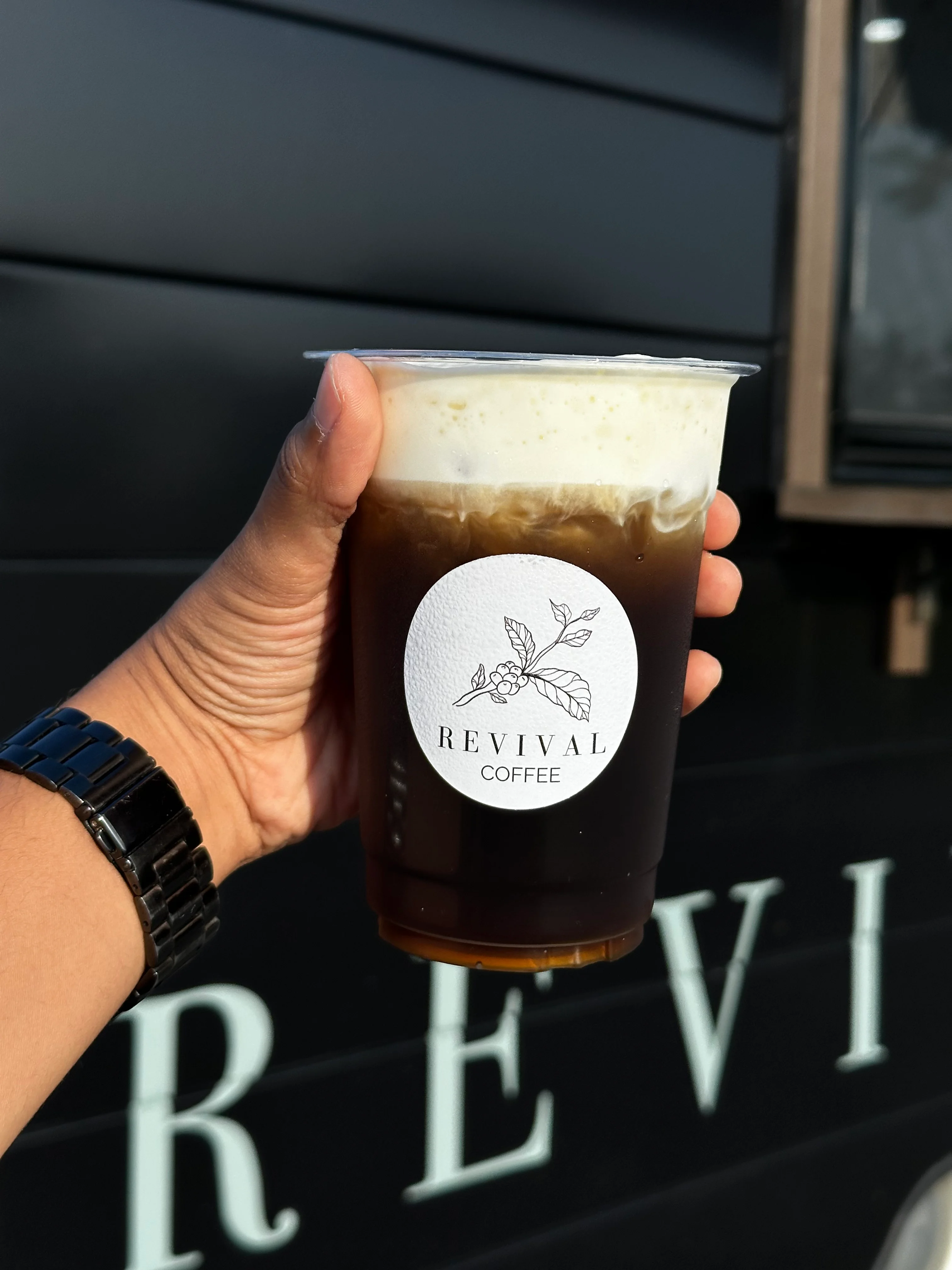 Cold brew coffee in branded cup from Revival Coffee