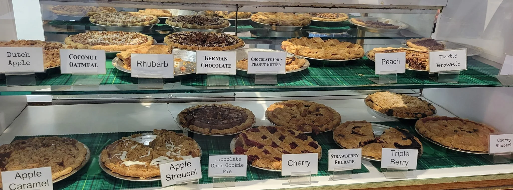 Display of assorted fruit pies including Dutch apple and German chocolate
