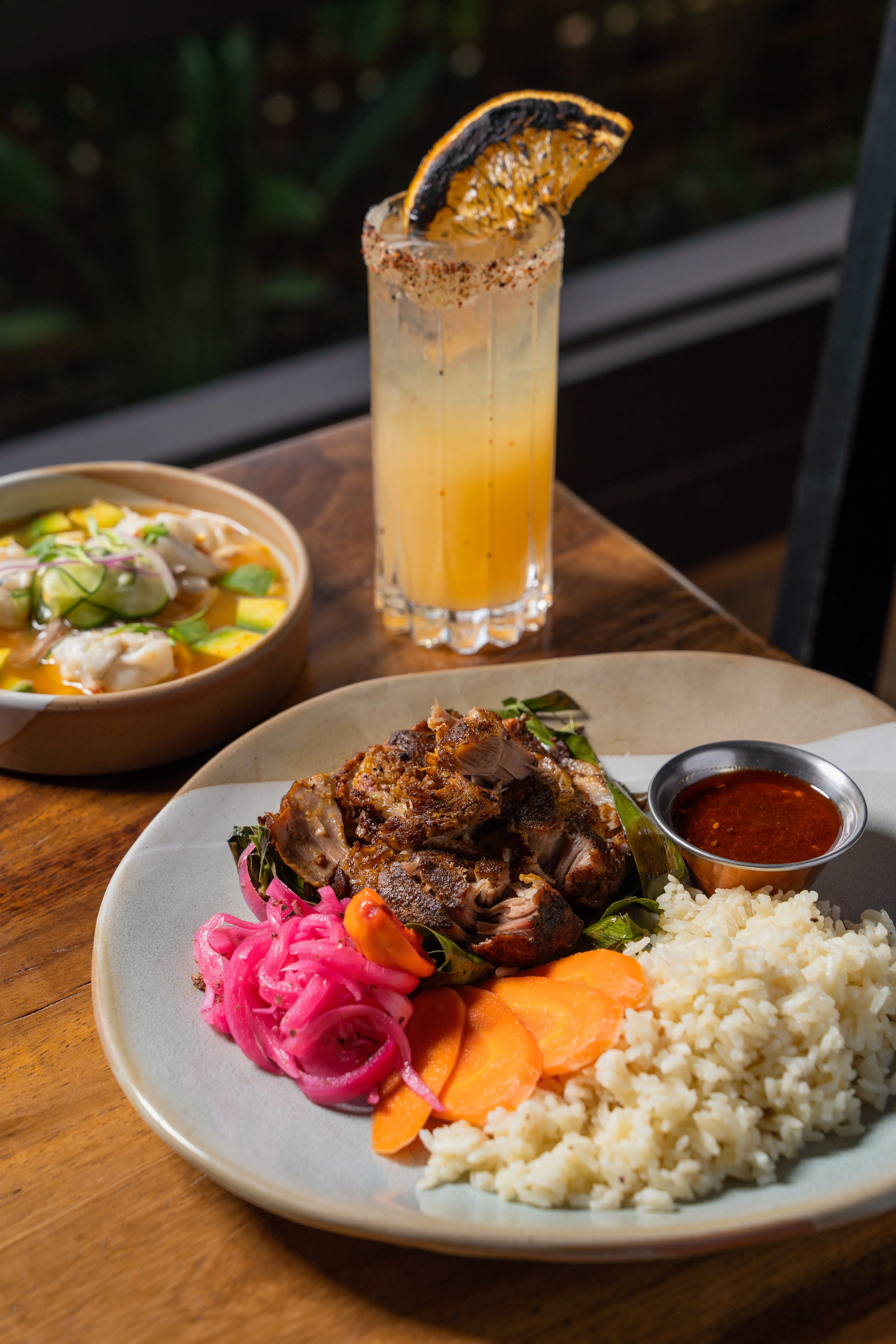 Plate of Indonesian nasi goreng with grilled meat and pickled vegetables