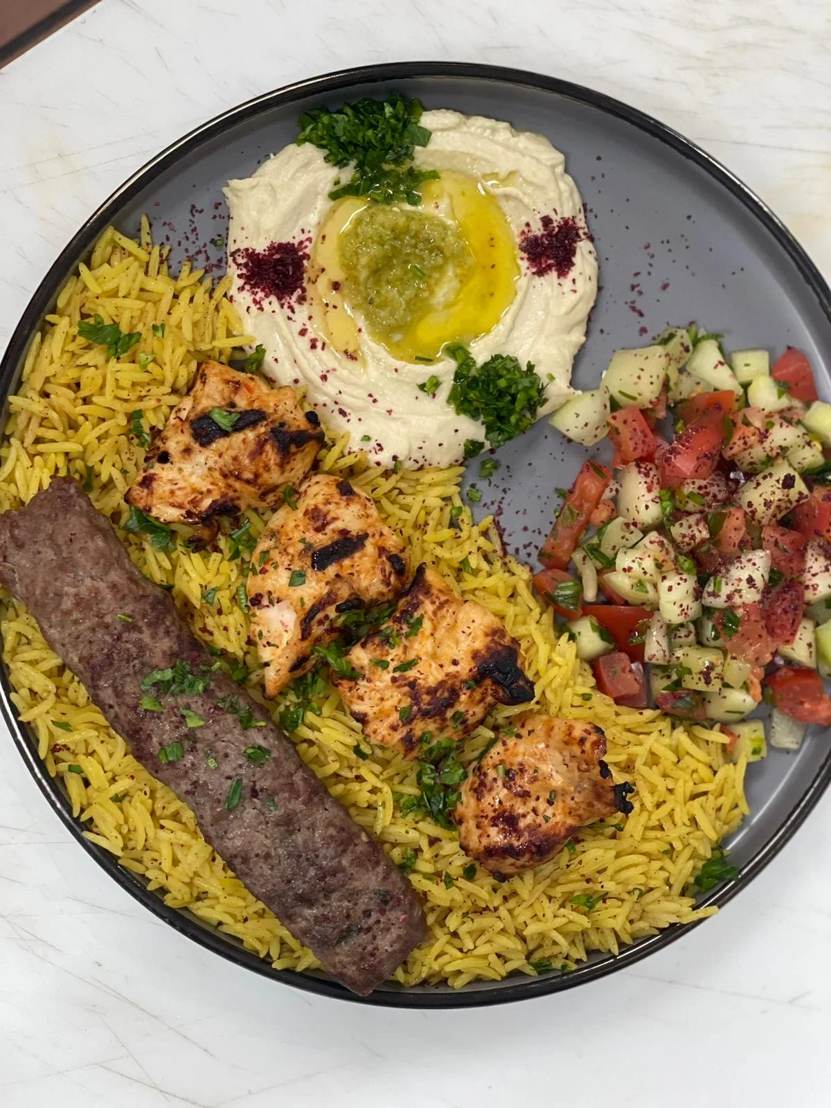 Mediterranean mixed grill platter with hummus and rice
