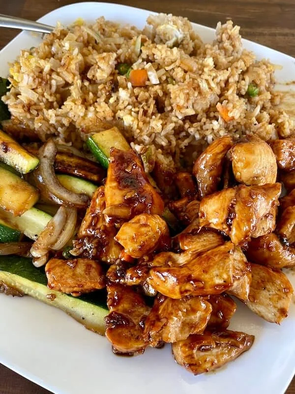 Delicious chicken teriyaki with fried rice and sautéed vegetables
