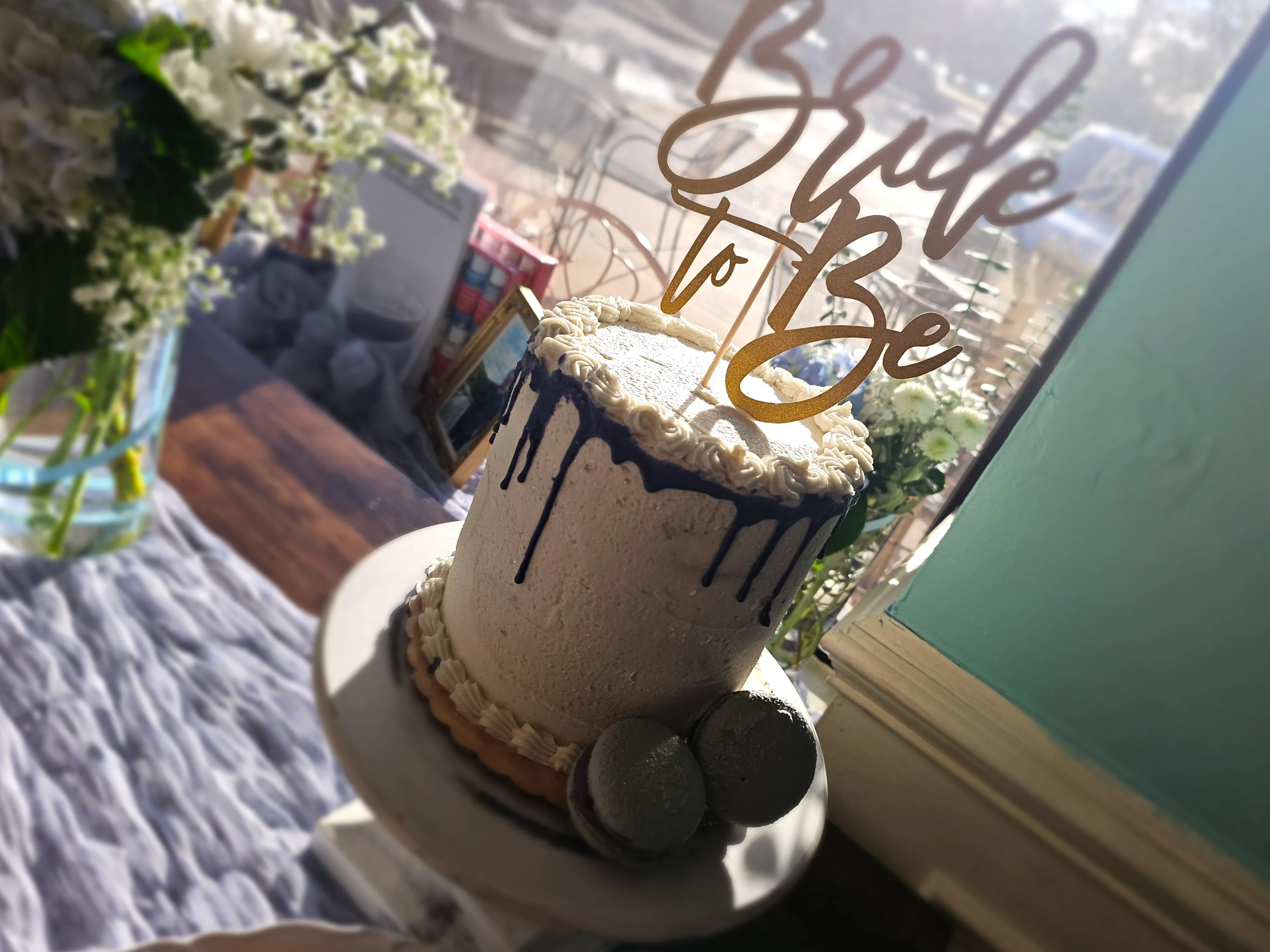 Elegant bridal cake with gold 'Bride to Be' topper
