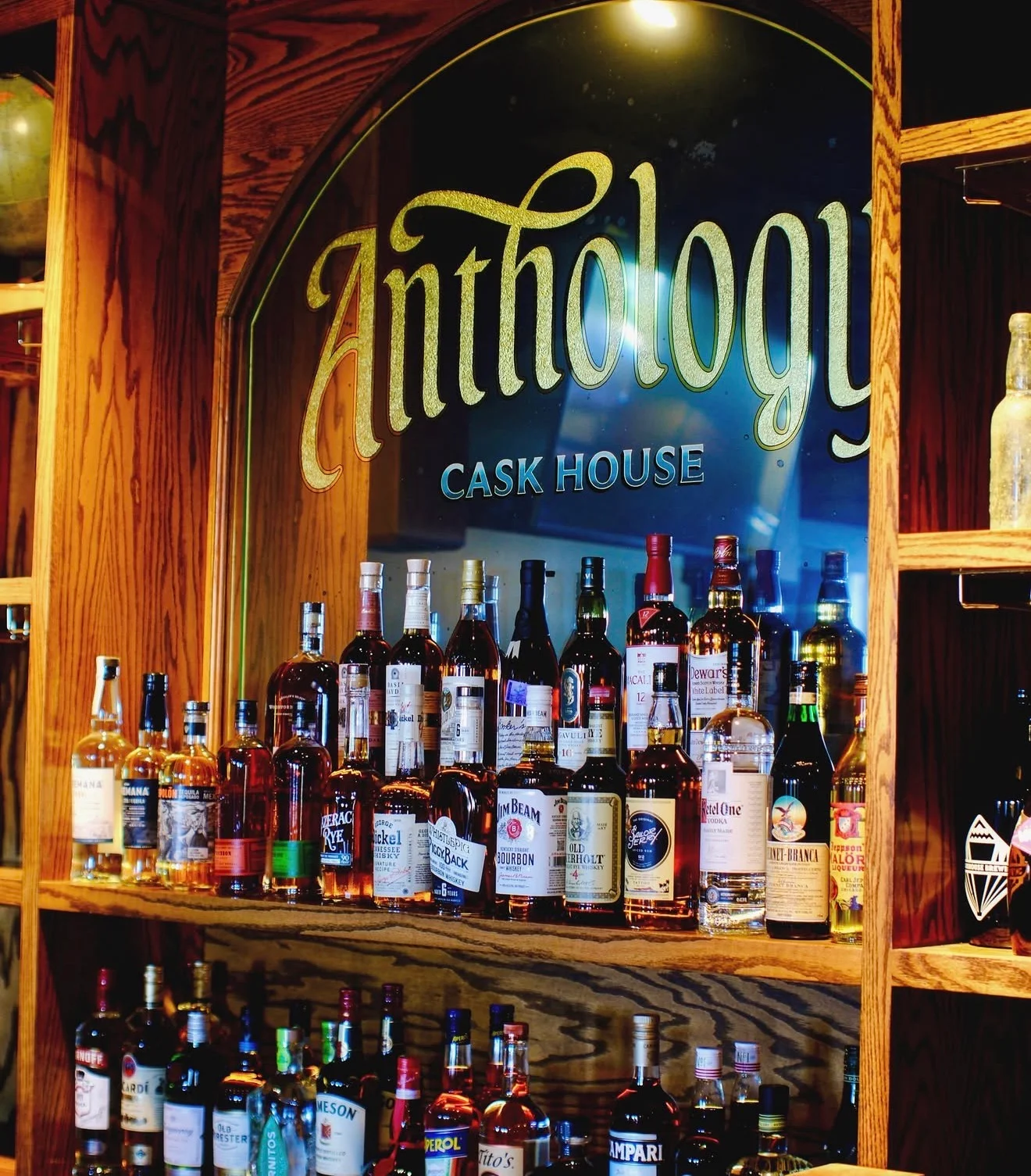 Well-stocked bar with various whiskey bottles and elegant signage