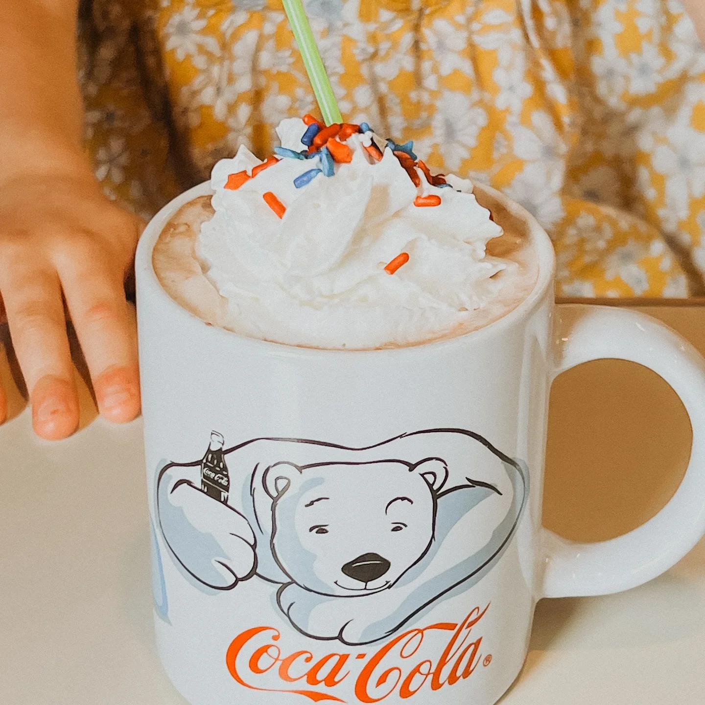 Frosty hot chocolate topped with whipped cream and sprinkles