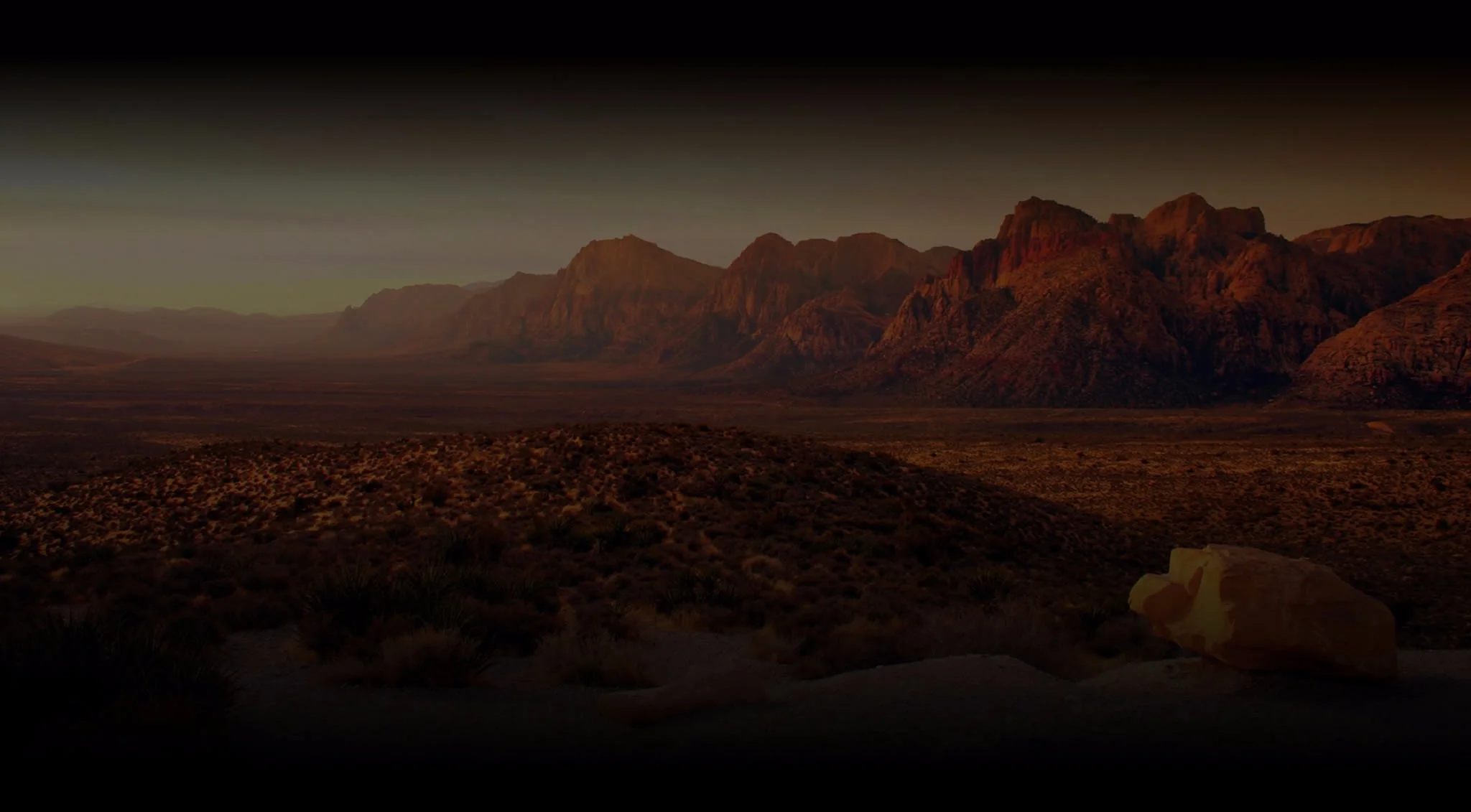 Desert landscape with mountains at sunset