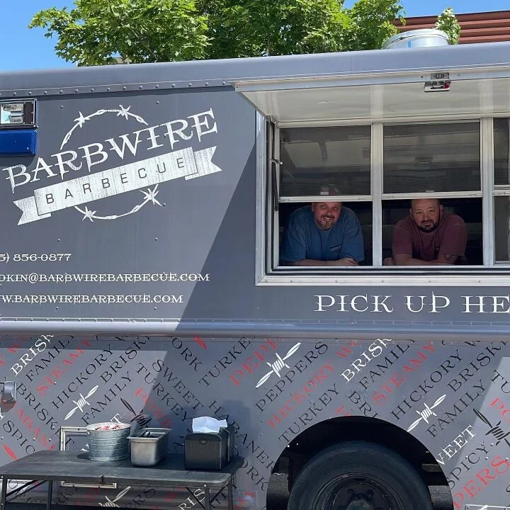 Barbecue food truck with friendly staff serving customers