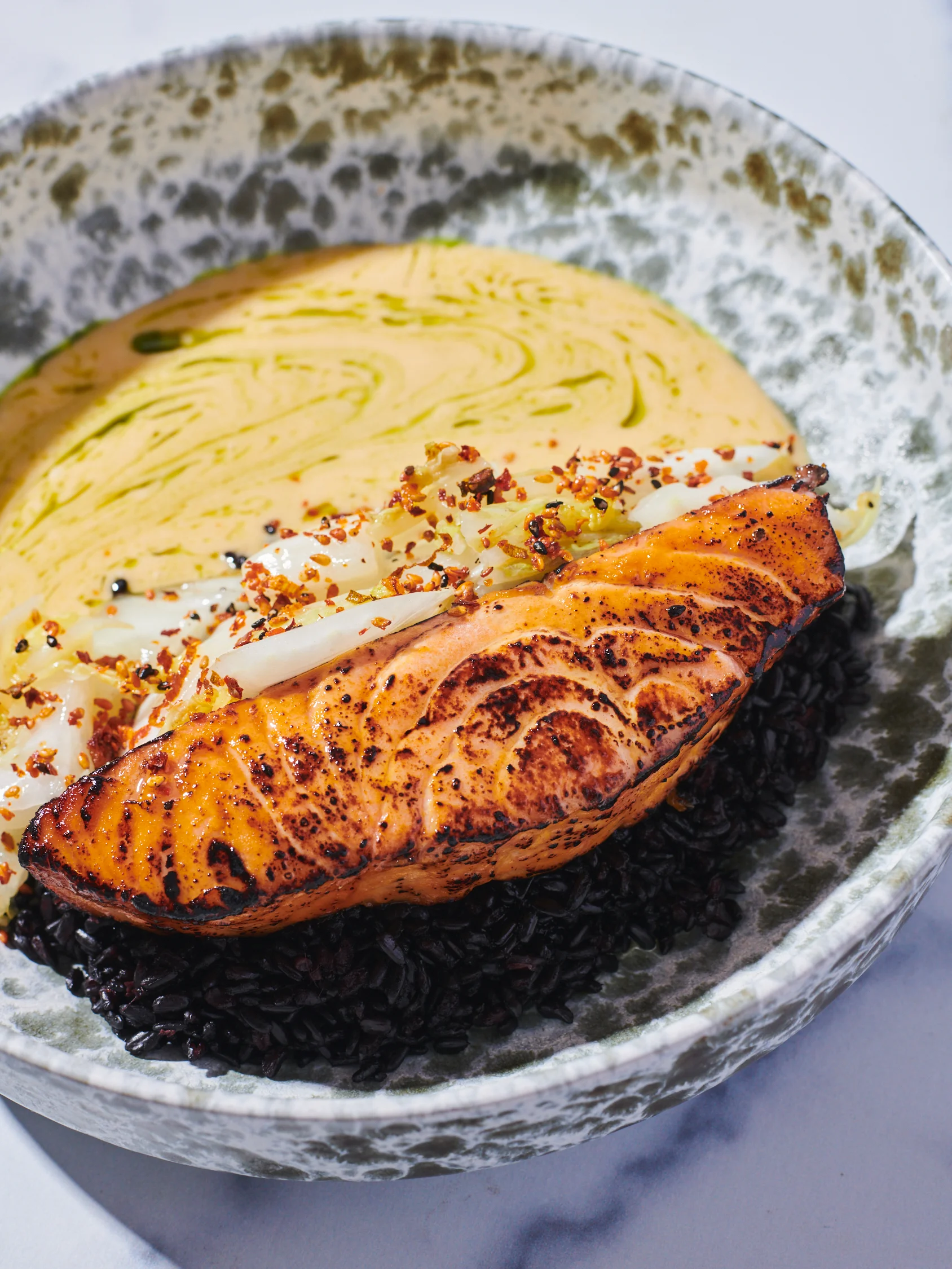 Grilled salmon with black rice and creamy sauce