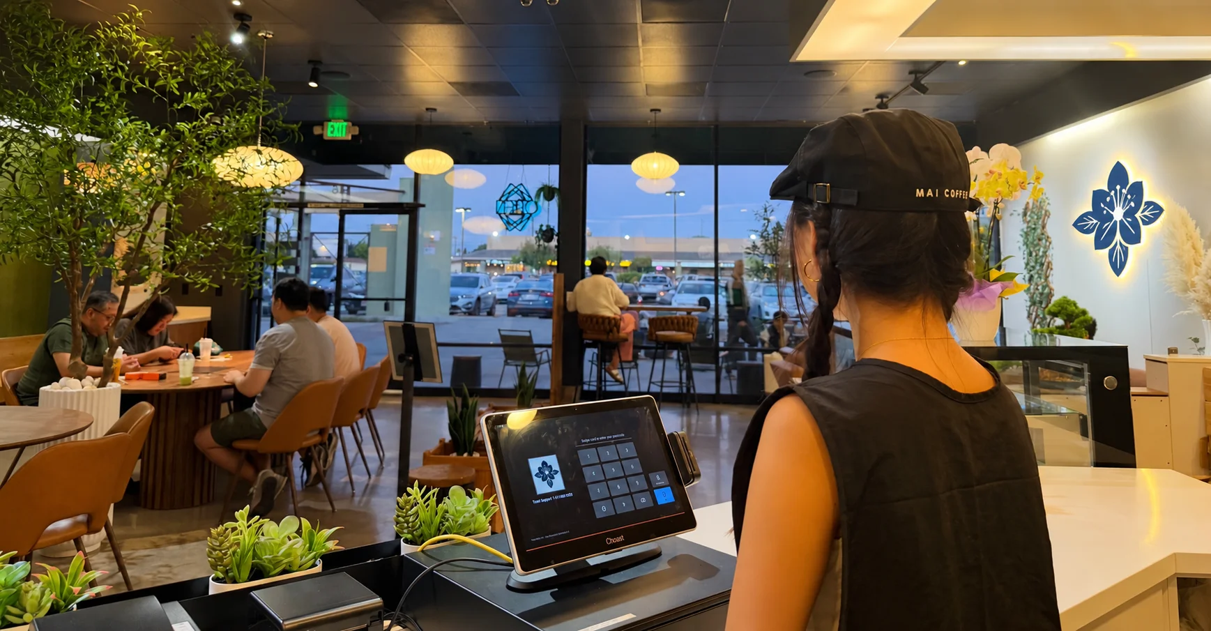 Modern café interior with customers enjoying drinks and a welcoming atmosphere
