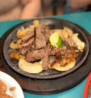 Sizzling fajitas with grilled beef and onions