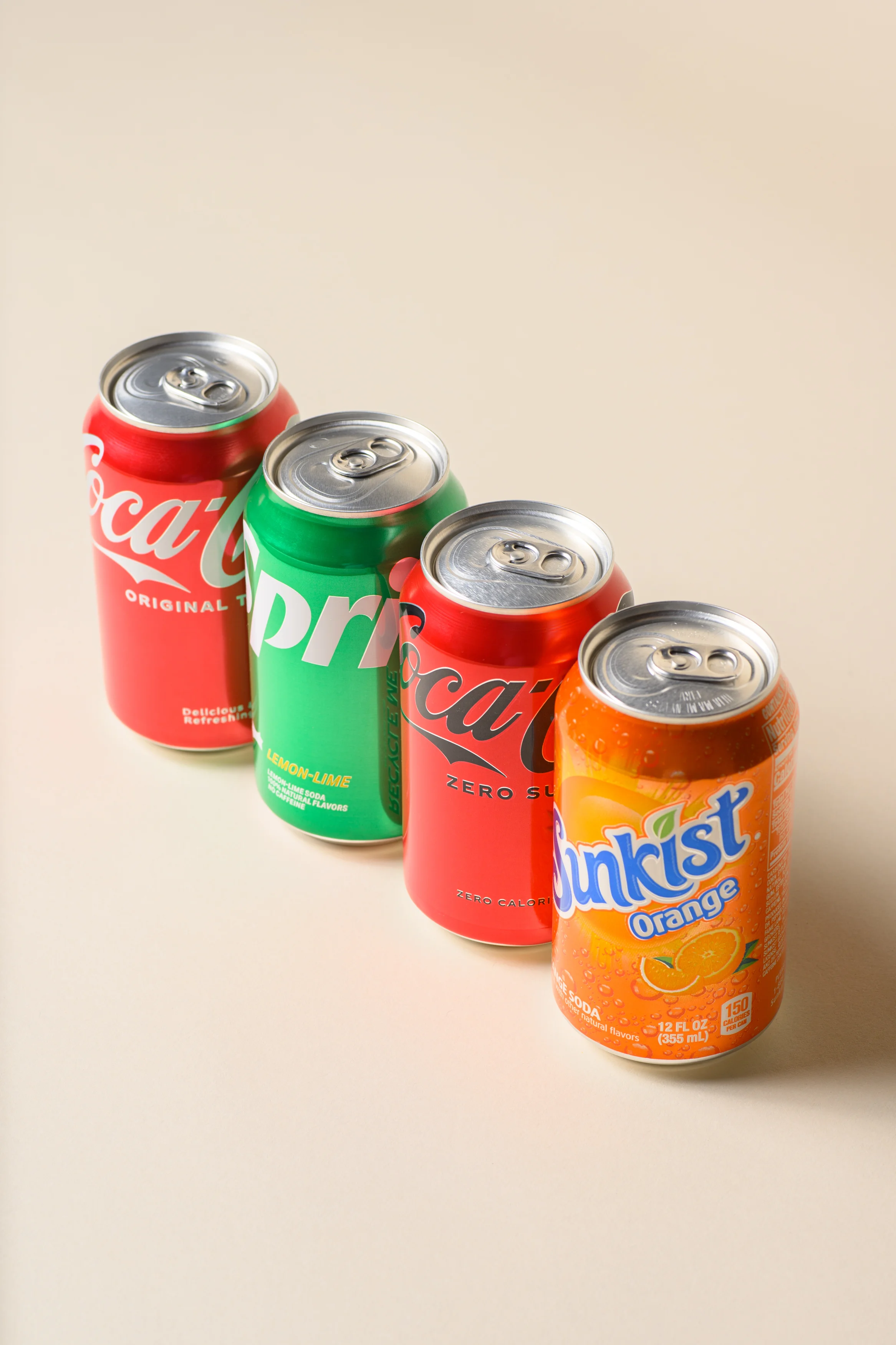 Variety of soda cans including Coca-Cola and Sunkist