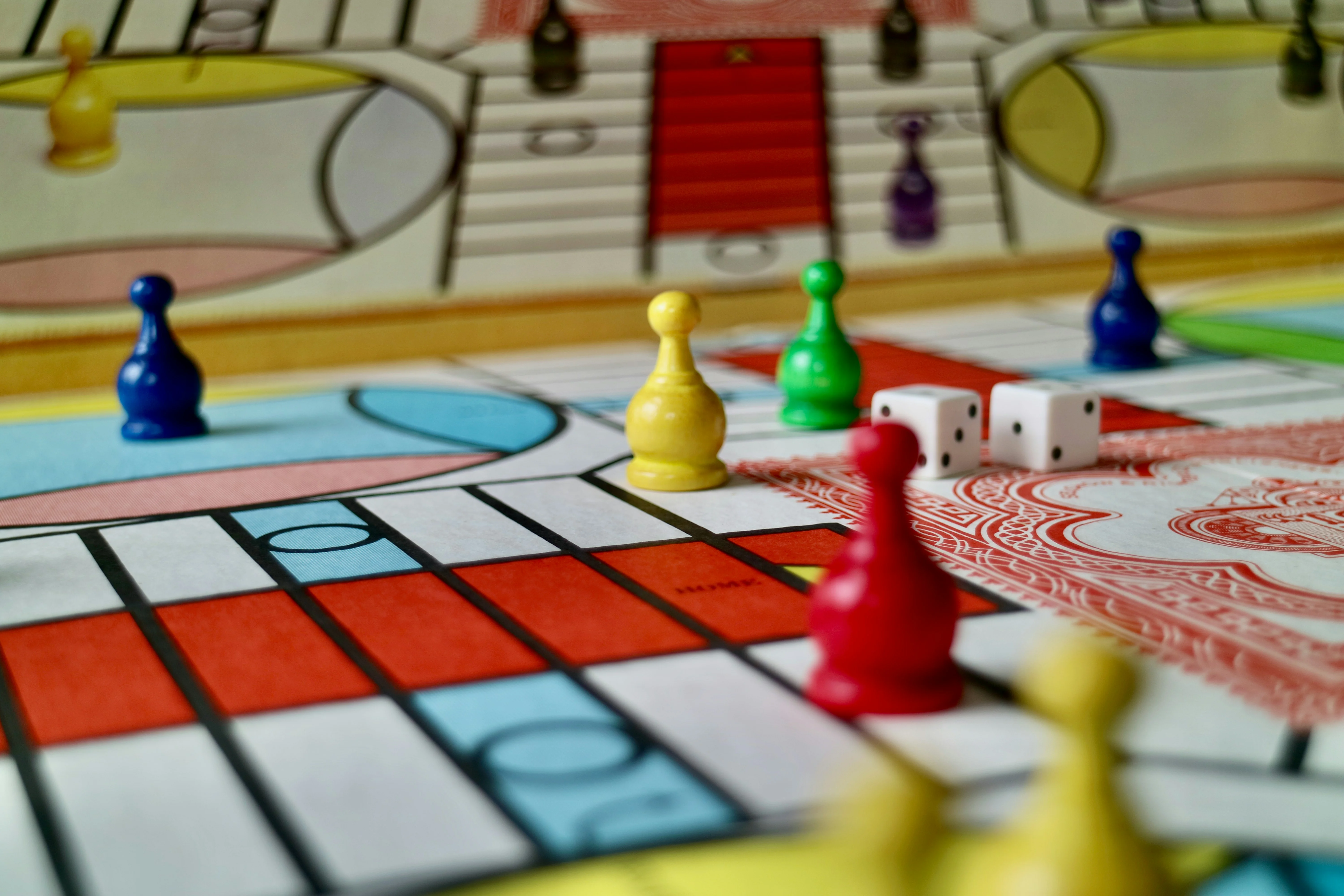 Colorful game pieces on a board game with dice