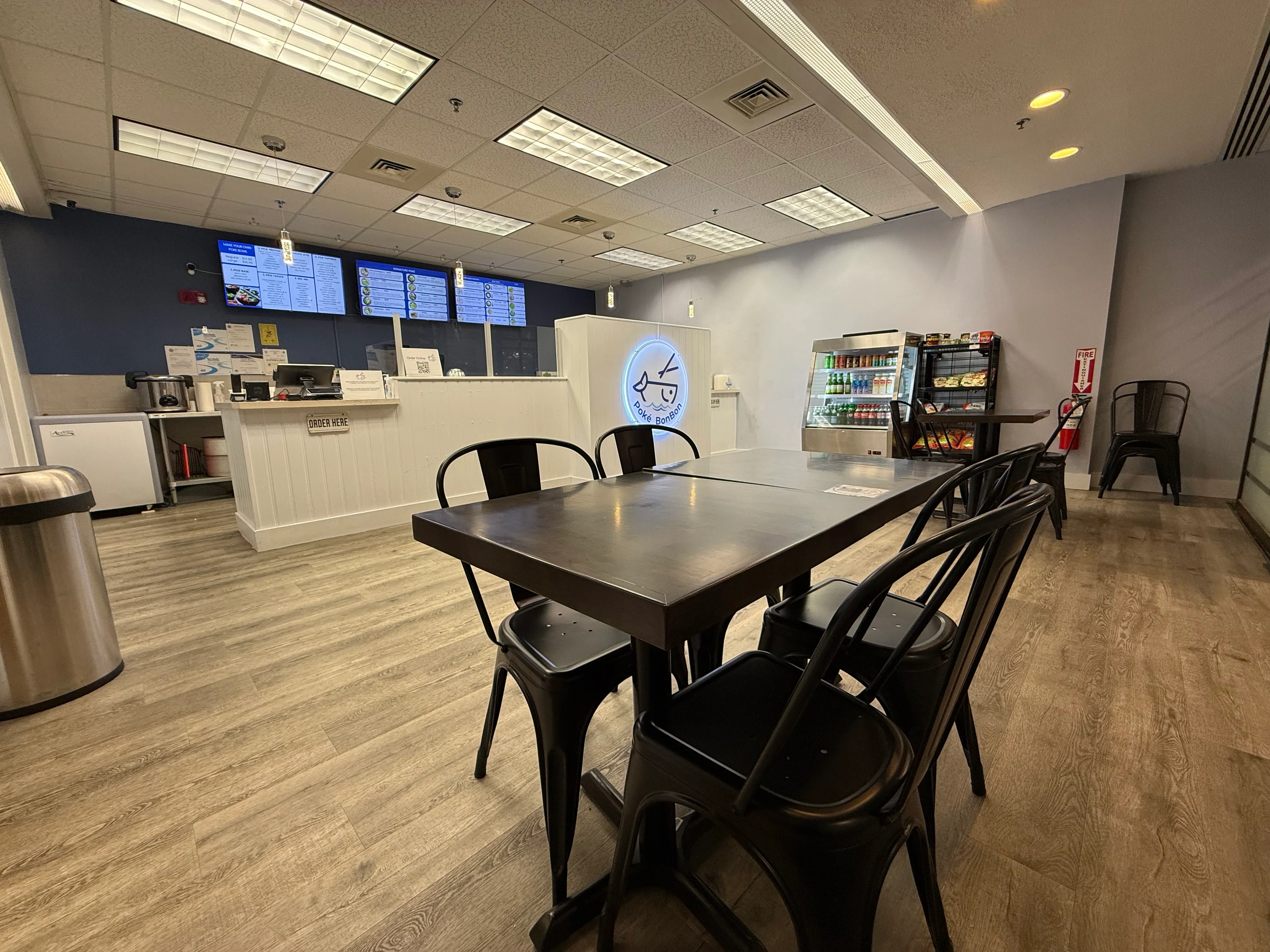 Modern restaurant interior with seating and menu displays