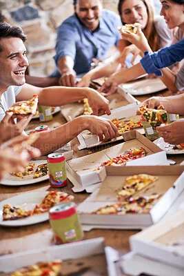 Group enjoying pizza at a lively gathering