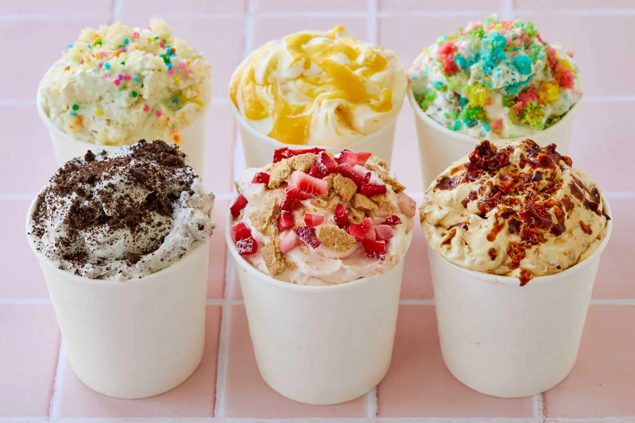 Colorful ice cream sundaes in paper cups