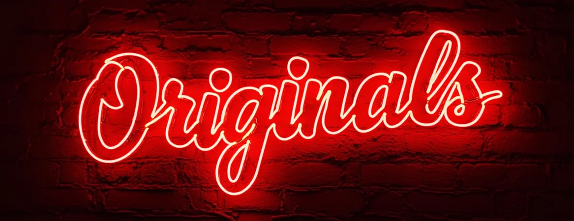 Neon sign reading 'Originals' on a brick wall