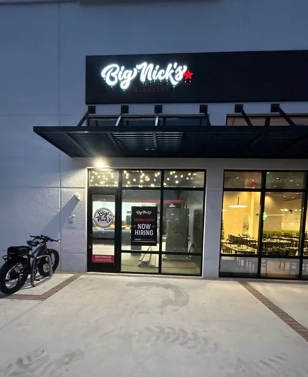 Exterior of Big Nick's Barbecue restaurant with hiring sign