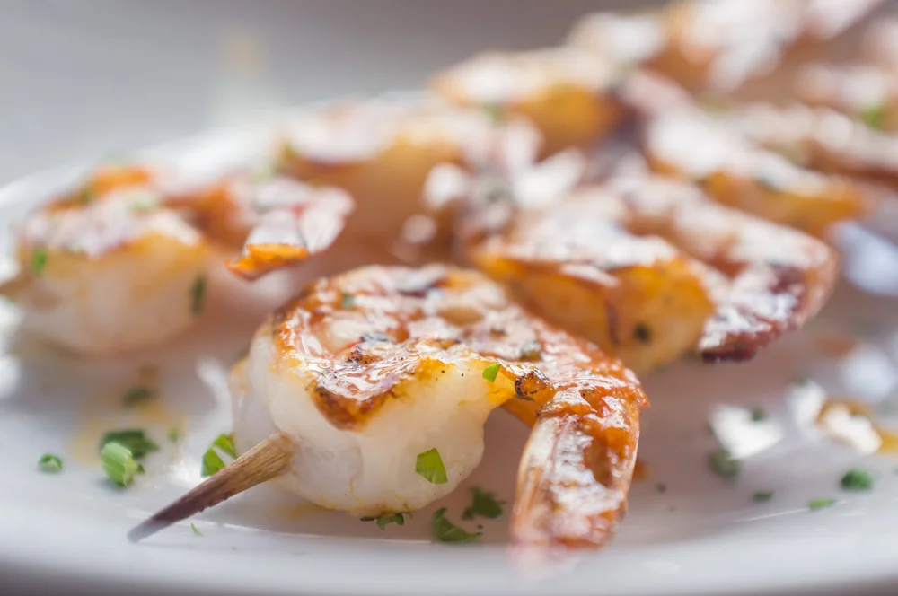 Grilled shrimp skewers with herbs
