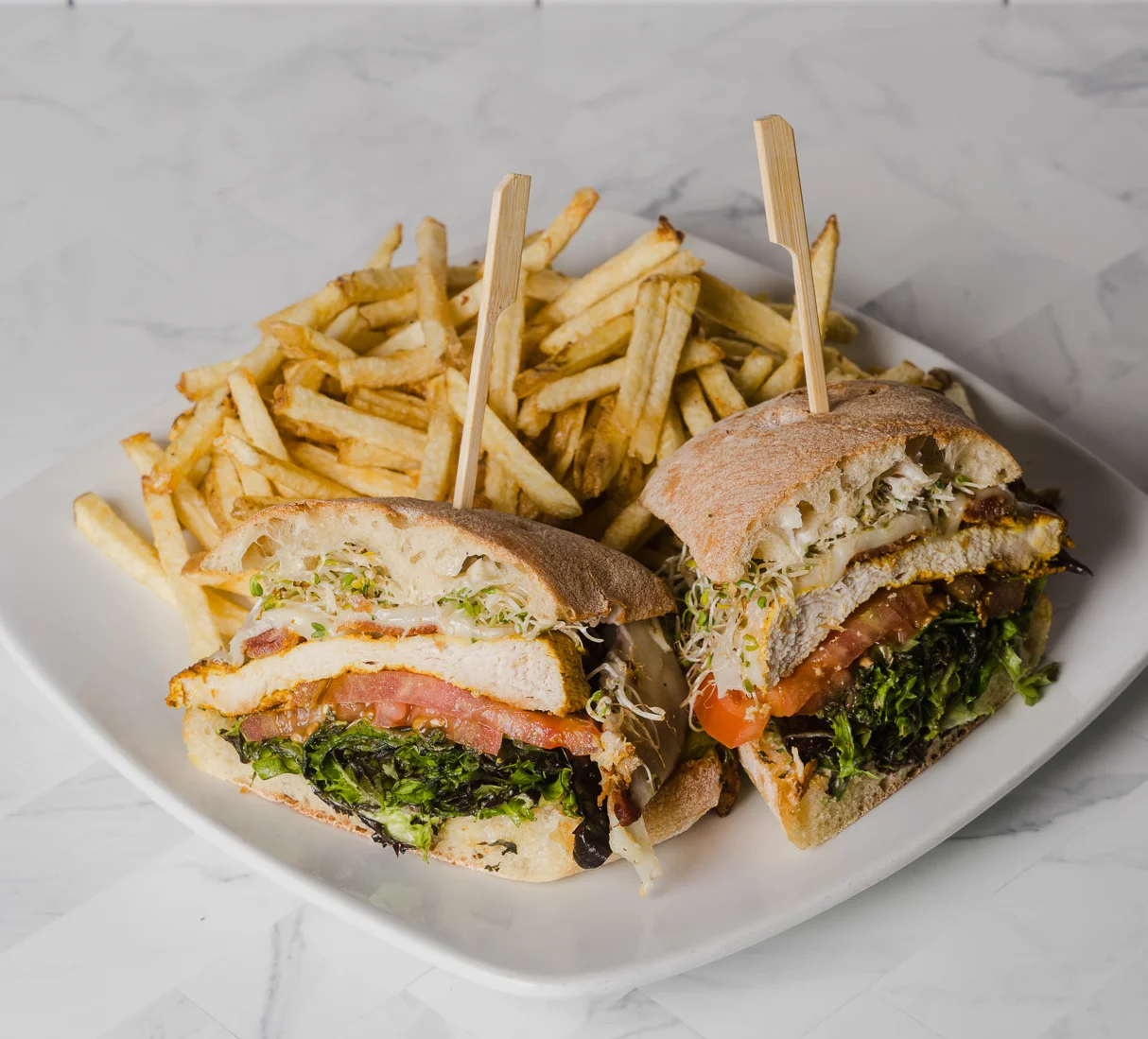 Chicken Club sandwich at Wild Carvery in Burbank with grilled chicken, bacon, avocado, tomato, mozzarella and house aioli on ciabatta