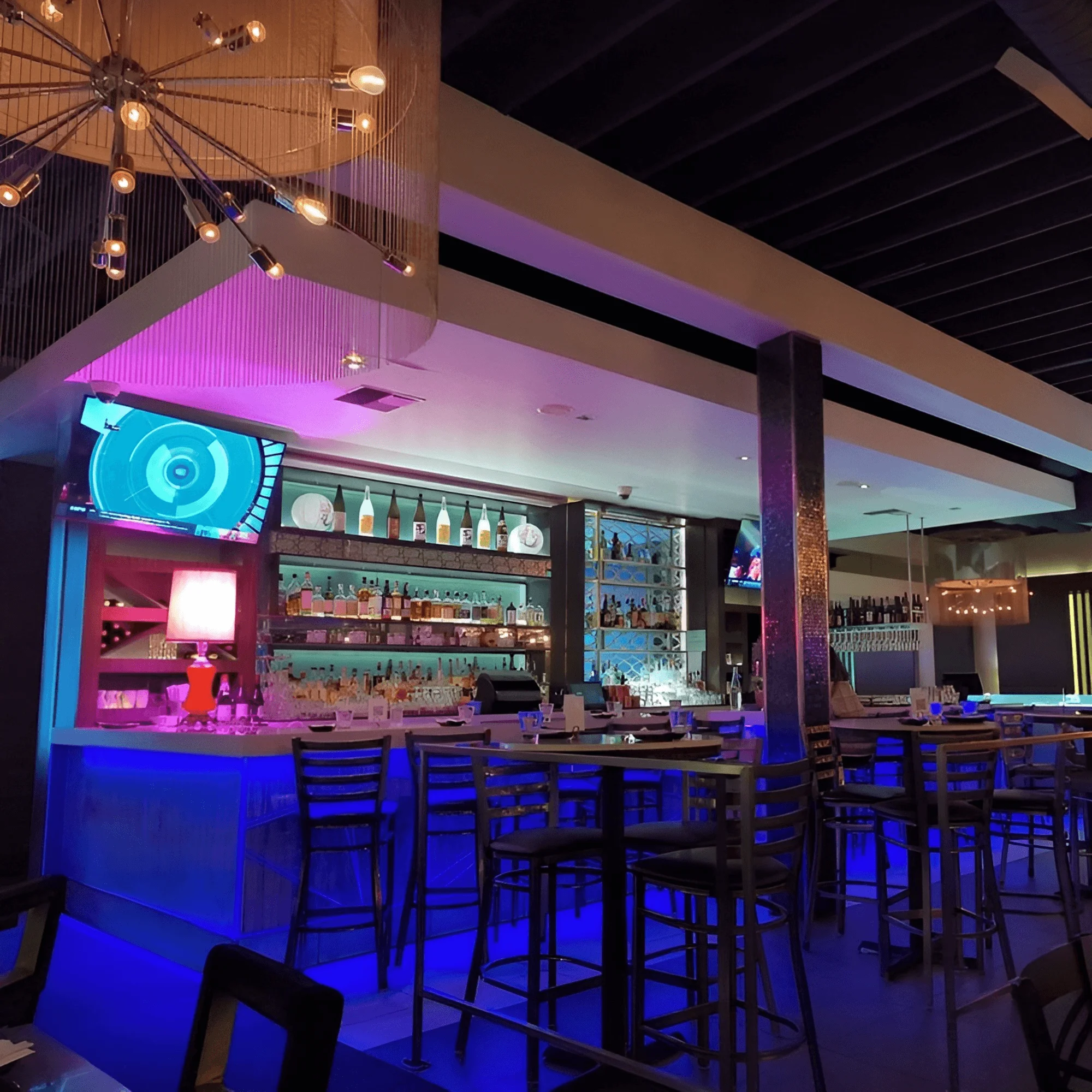 Modern bar interior with vibrant lighting and stylish decor