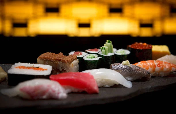 Assorted Japanese sushi platter on a black stone plate