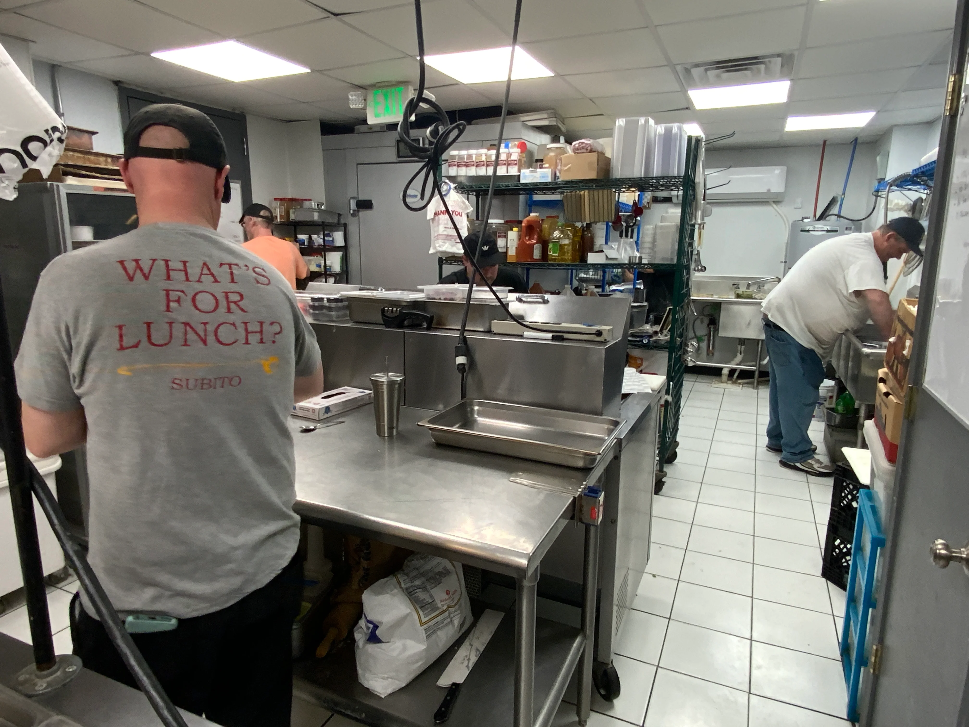 Dave pours the melty cheese over the just-made pasta noodles for the in-house macaroni salad.