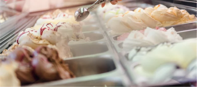 An employee scooping out some fresh ice cream