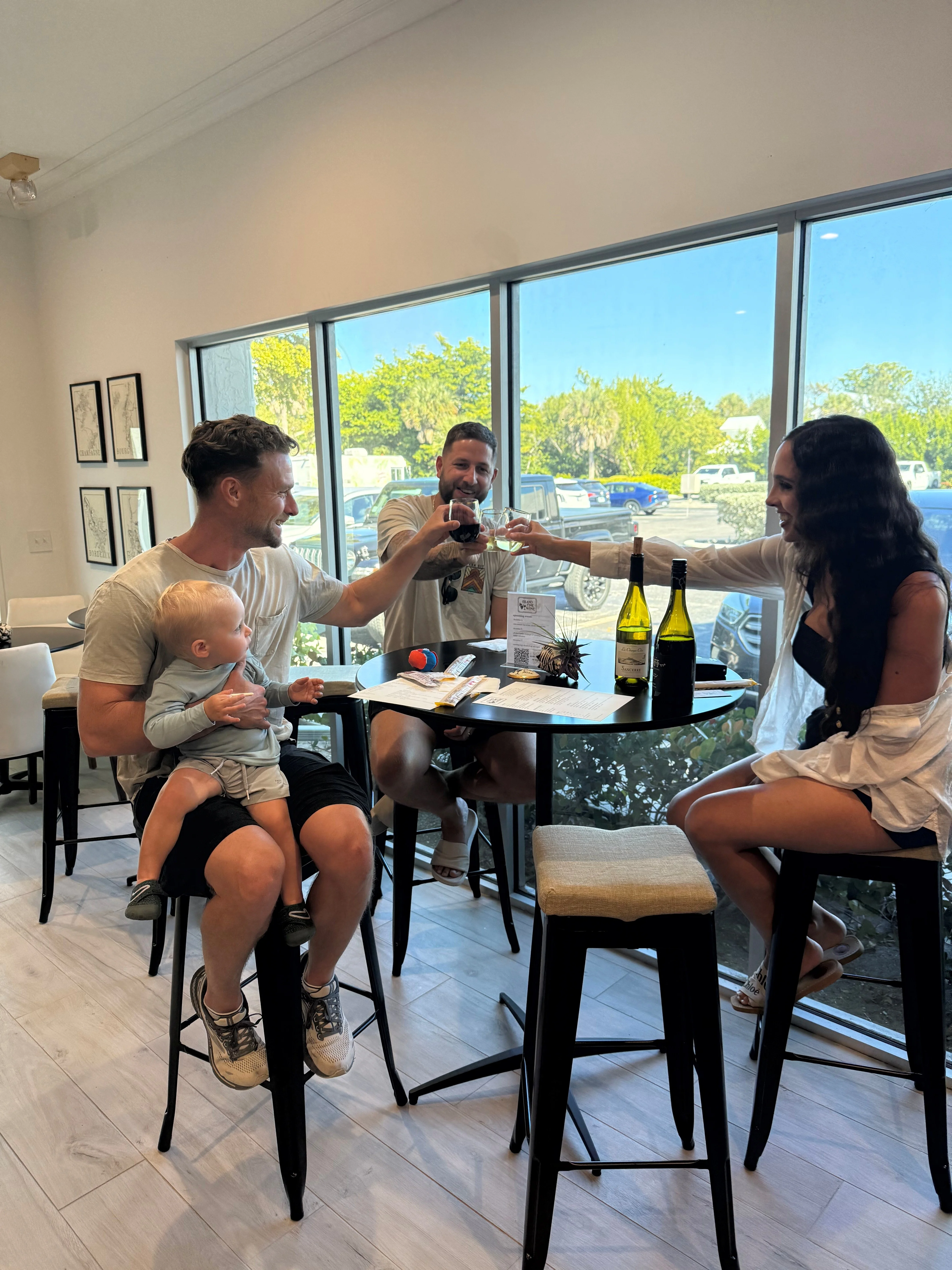 Friends toasting with wine in a modern restaurant setting.