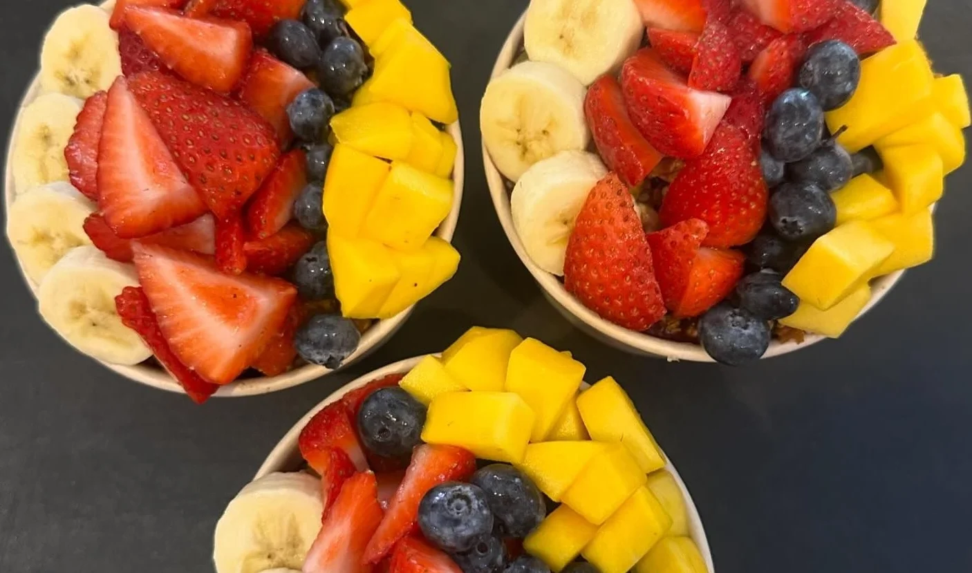 Colorful fruit bowls with strawberries, mango, and blueberries