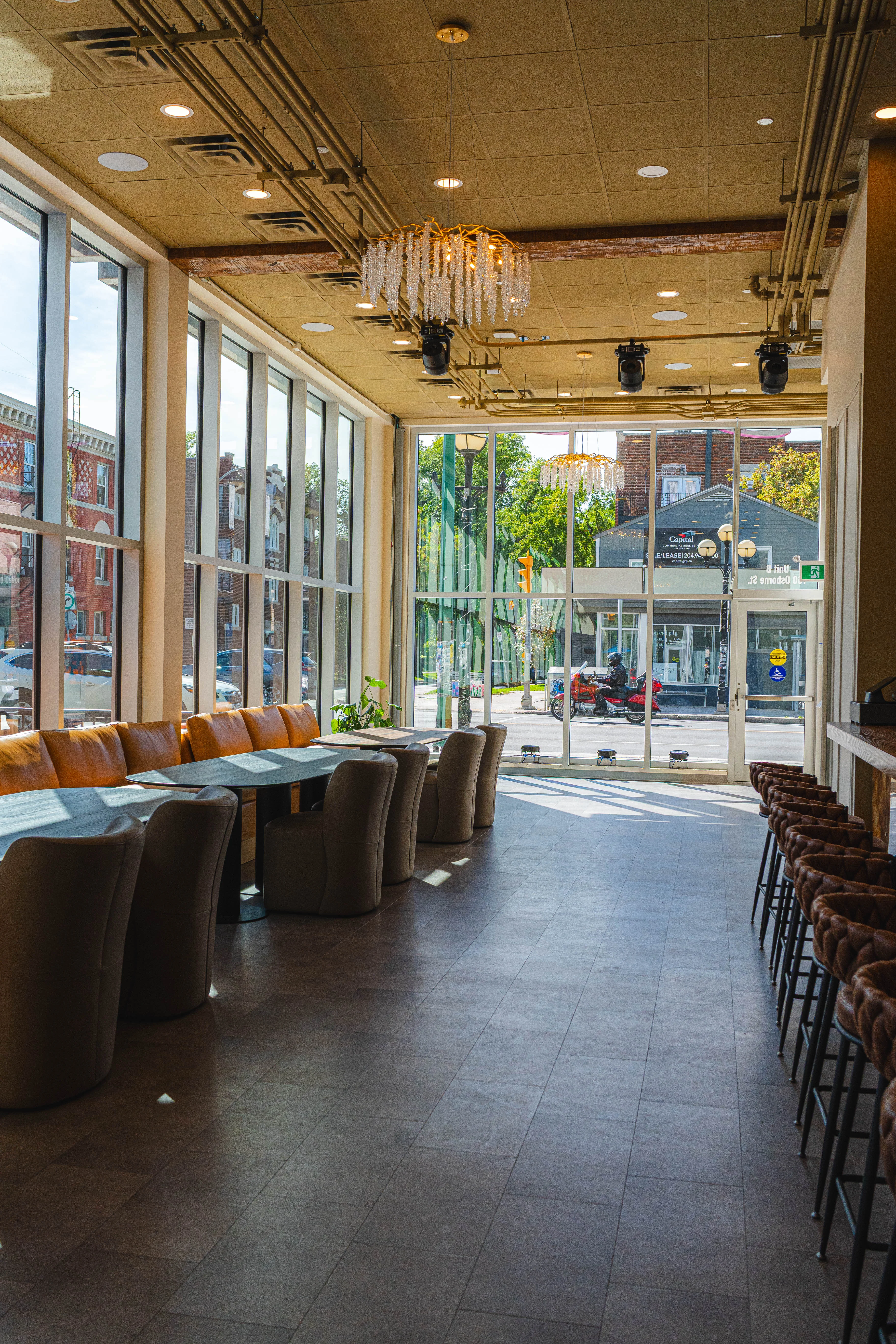 Modern restaurant interior with large windows and stylish seating