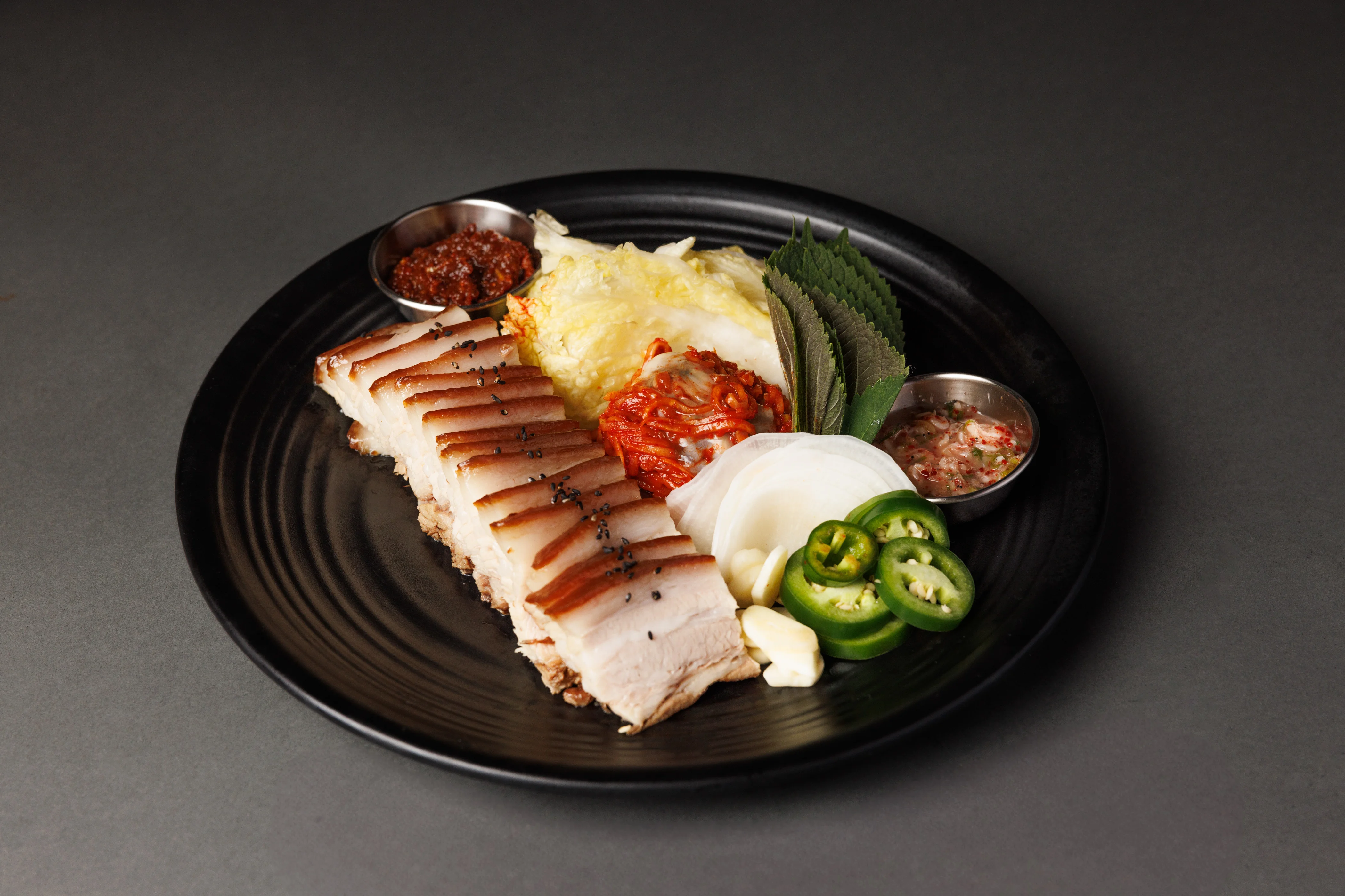 Korean bossam platter with pork belly and side dishes