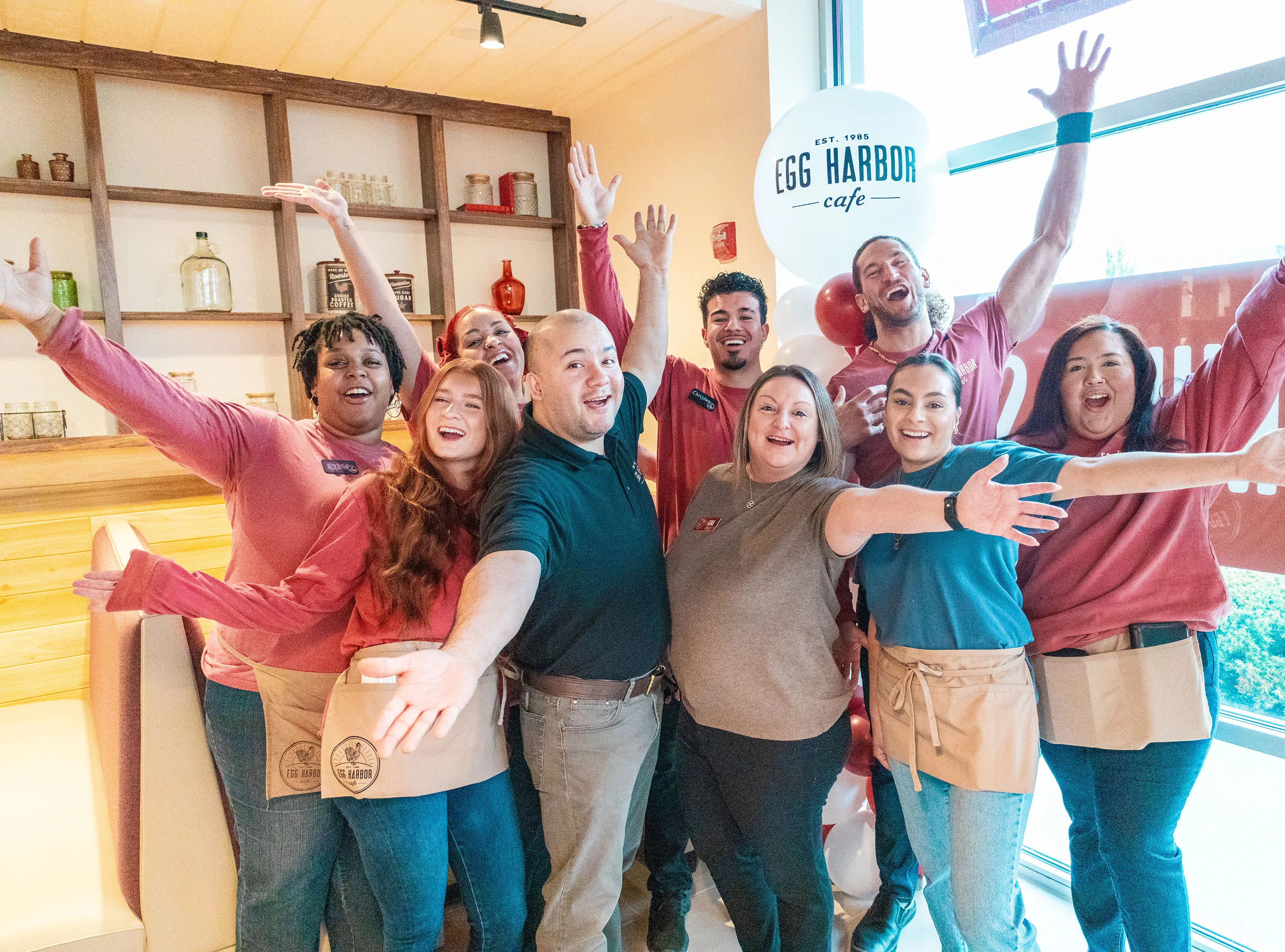 Cheerful restaurant staff celebrating at Egg Harbor Cafe