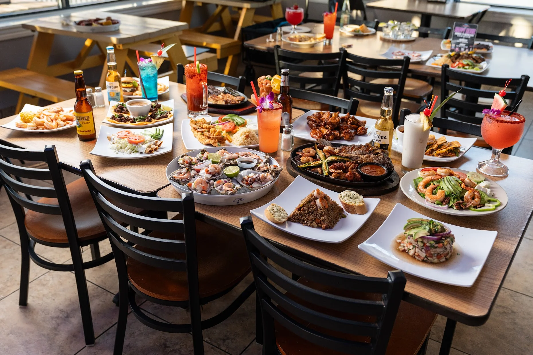 Vibrant seafood platter with tropical cocktails in a lively restaurant setting