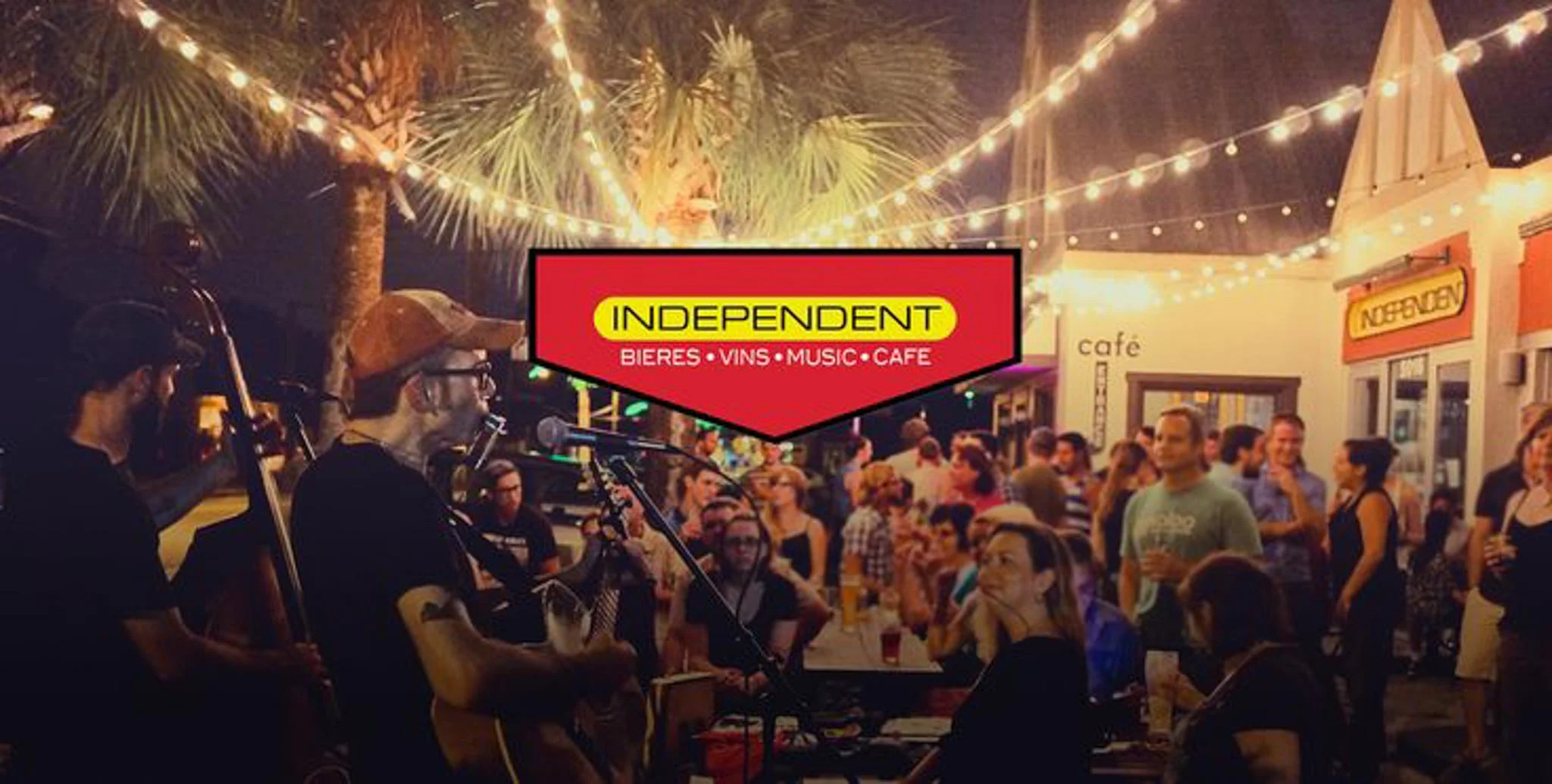 Live music performance at a vibrant outdoor café with string lights.