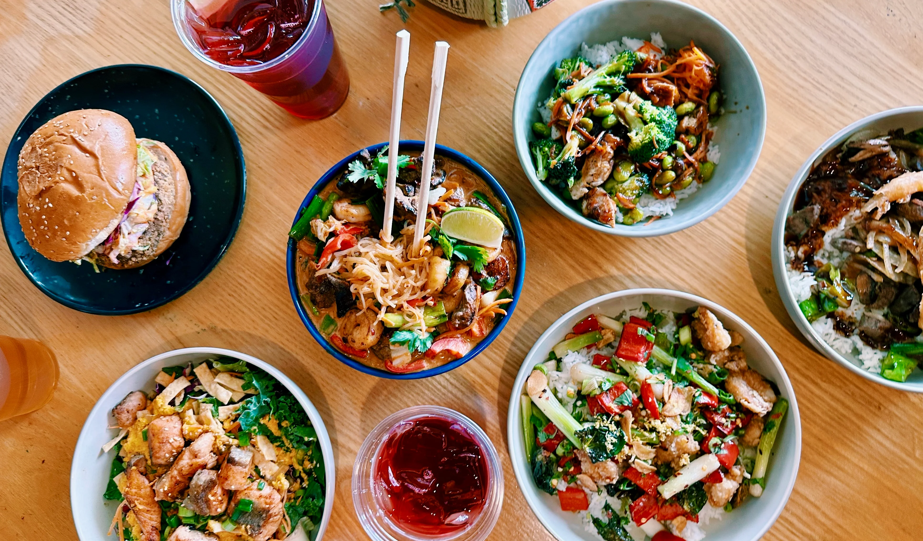 Three bowls of colorful Japanese dishes with fresh ingredients.
