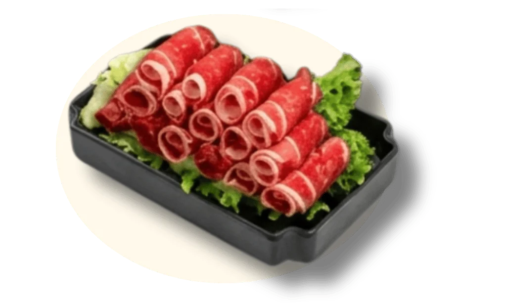 Thinly sliced beef on a bed of lettuce in a black tray.