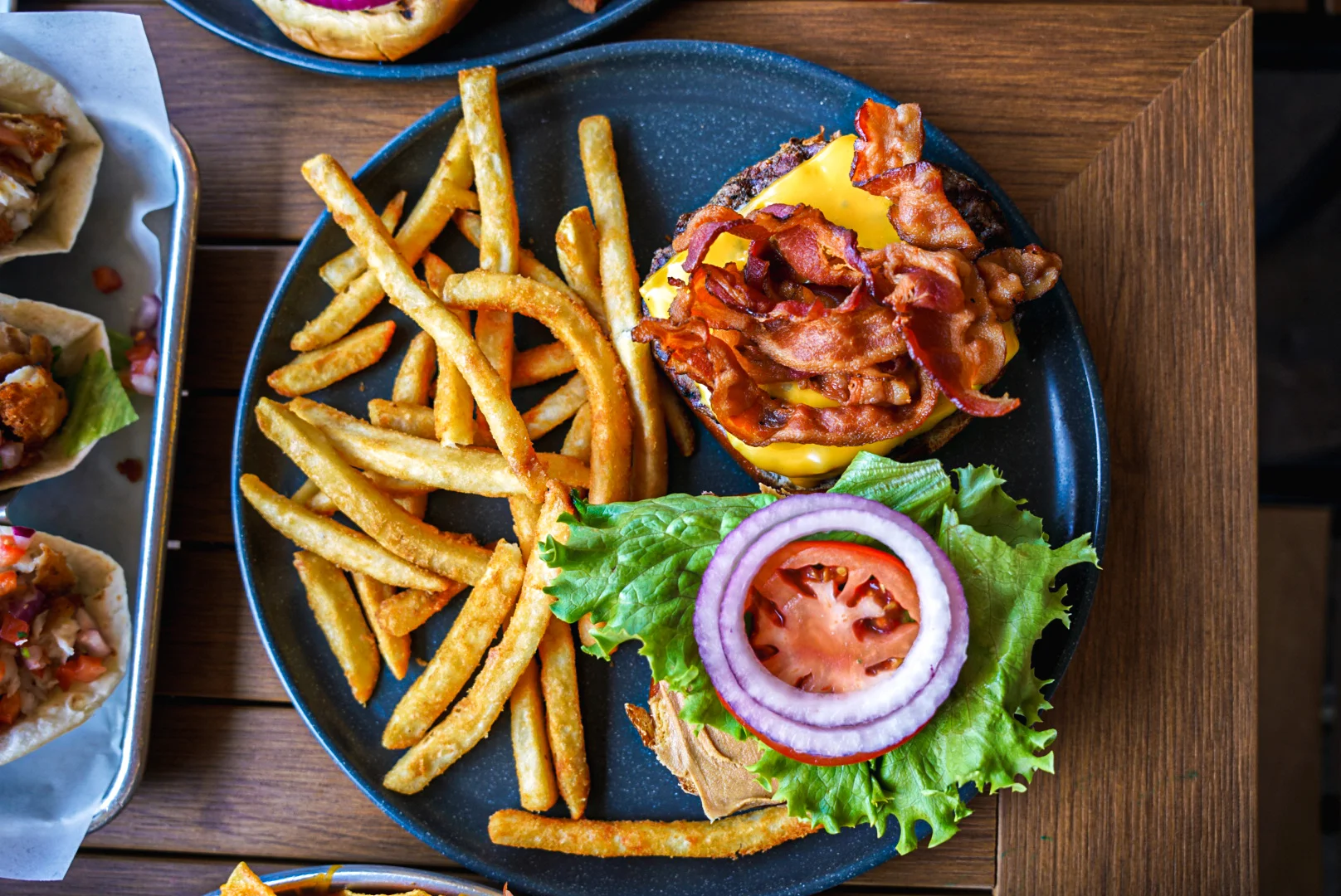 Classic American cheeseburger with bacon and fries