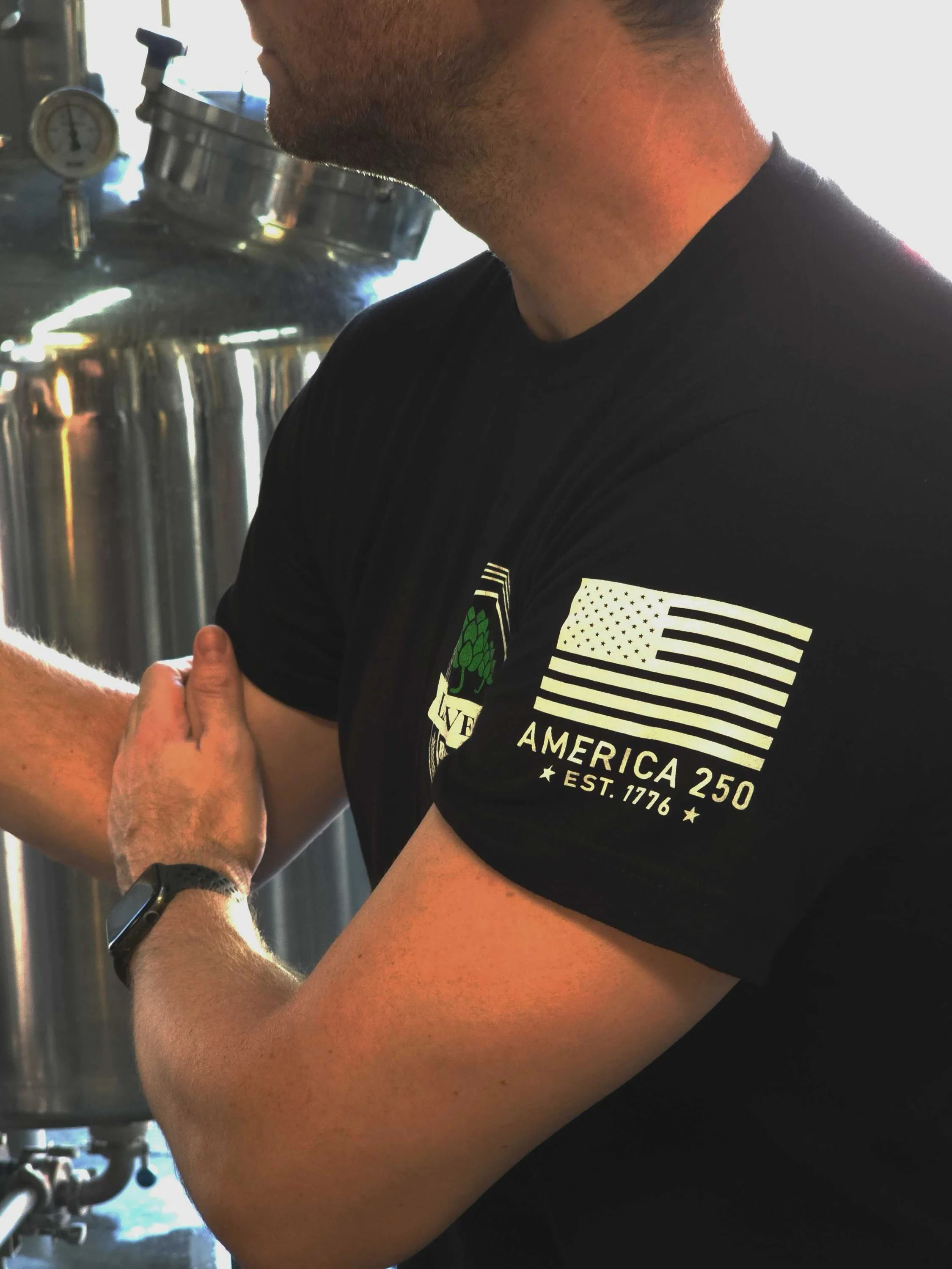 Person in a black shirt working in a brewery
