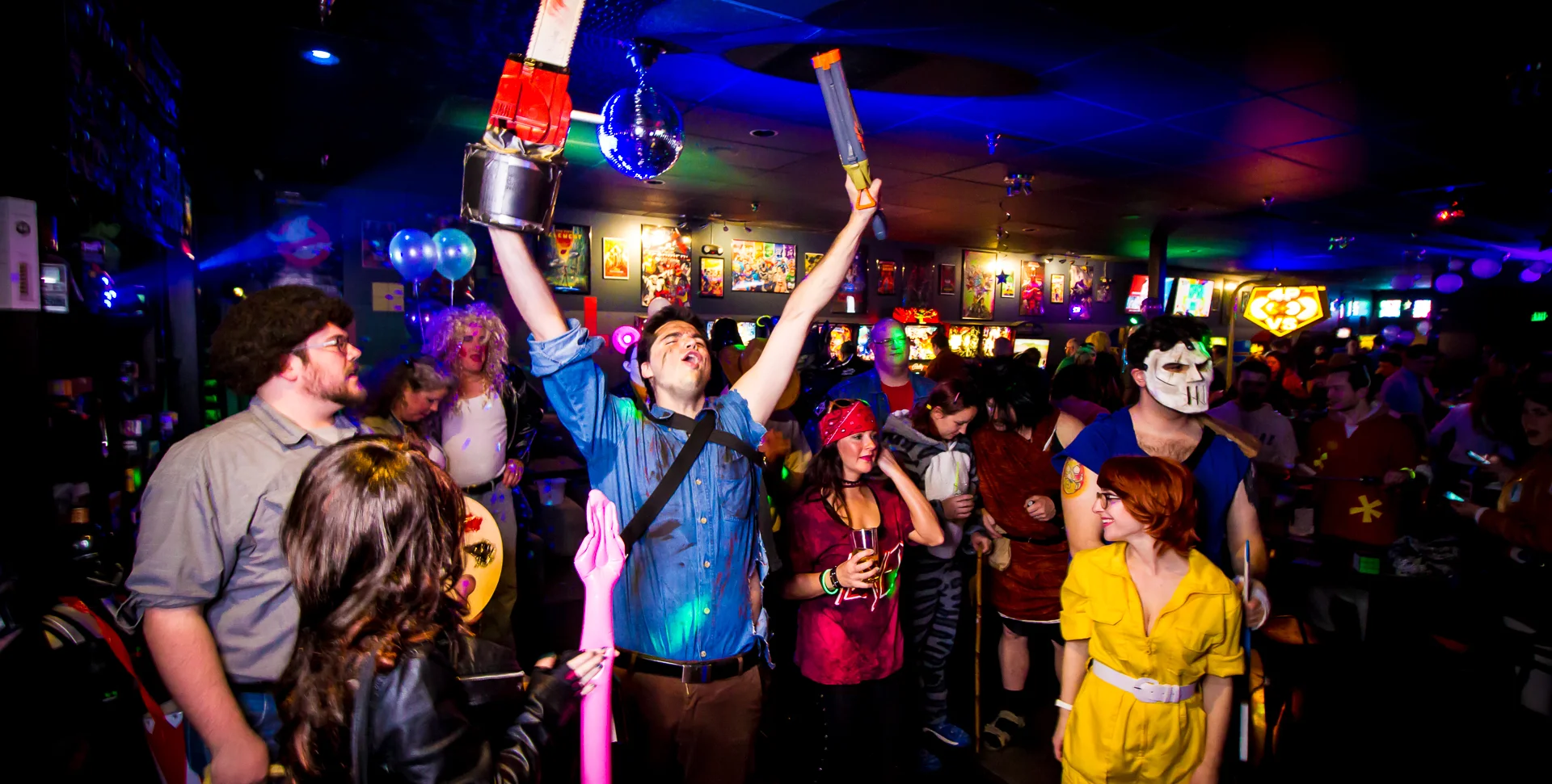 Costumed partygoers celebrating in a vibrant bar atmosphere