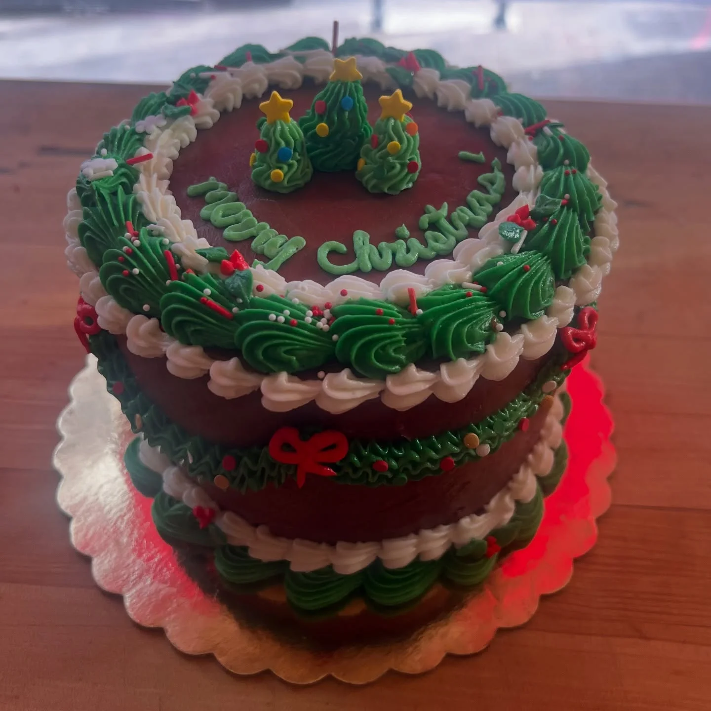 Festive Christmas cake decorated with green frosting and holiday motifs