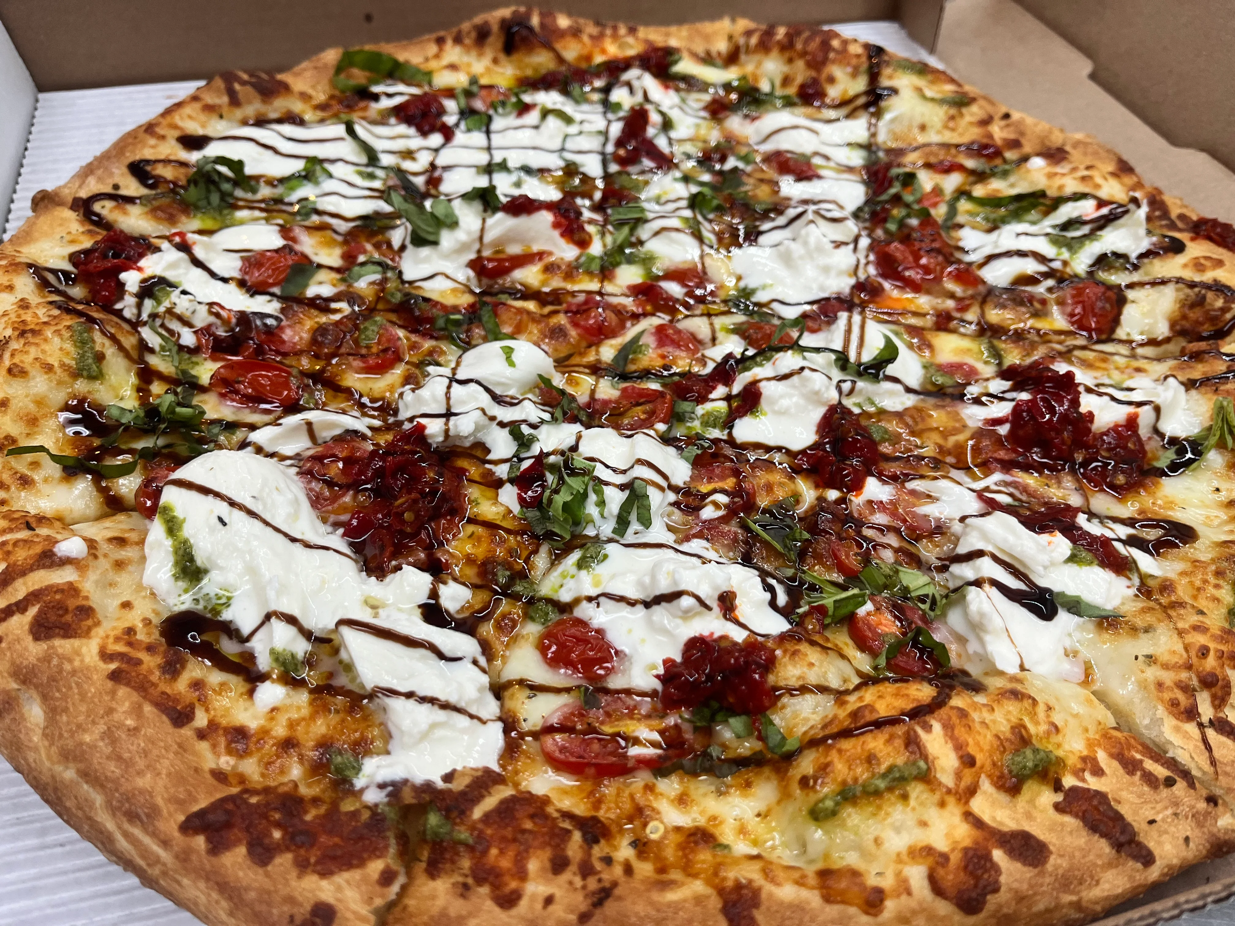 Burrata pizza with Calabrian chili drizzle