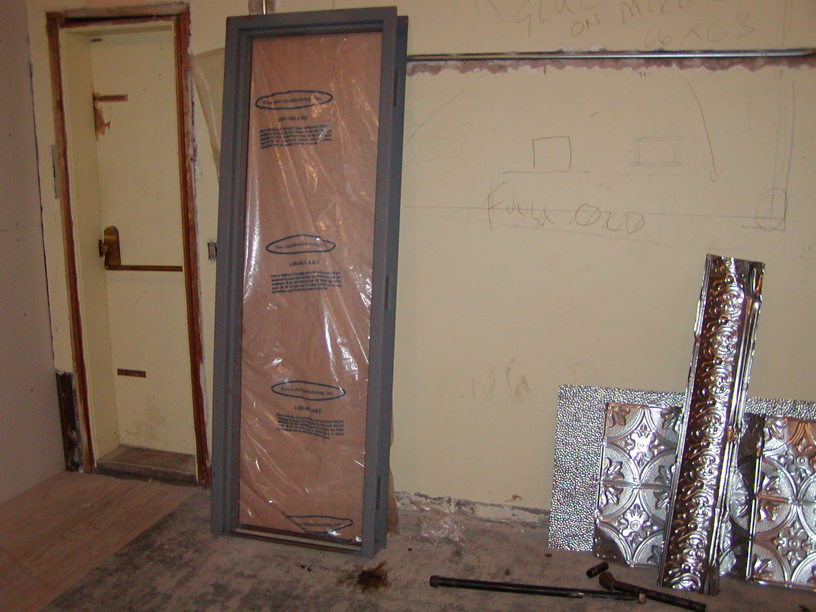 Construction area with door frame and decorative metal panels