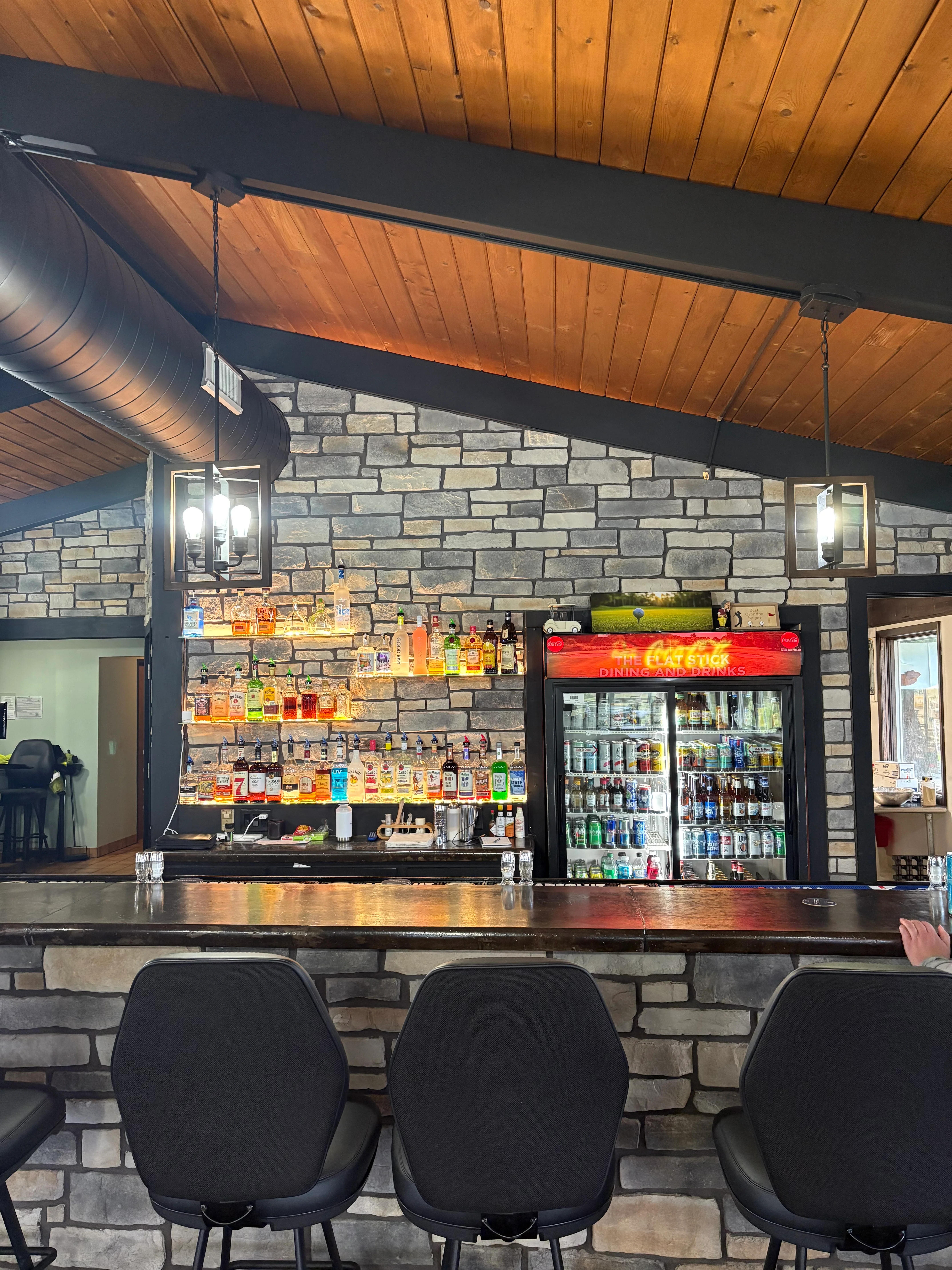 Modern bar interior with stone wall and stylish seating