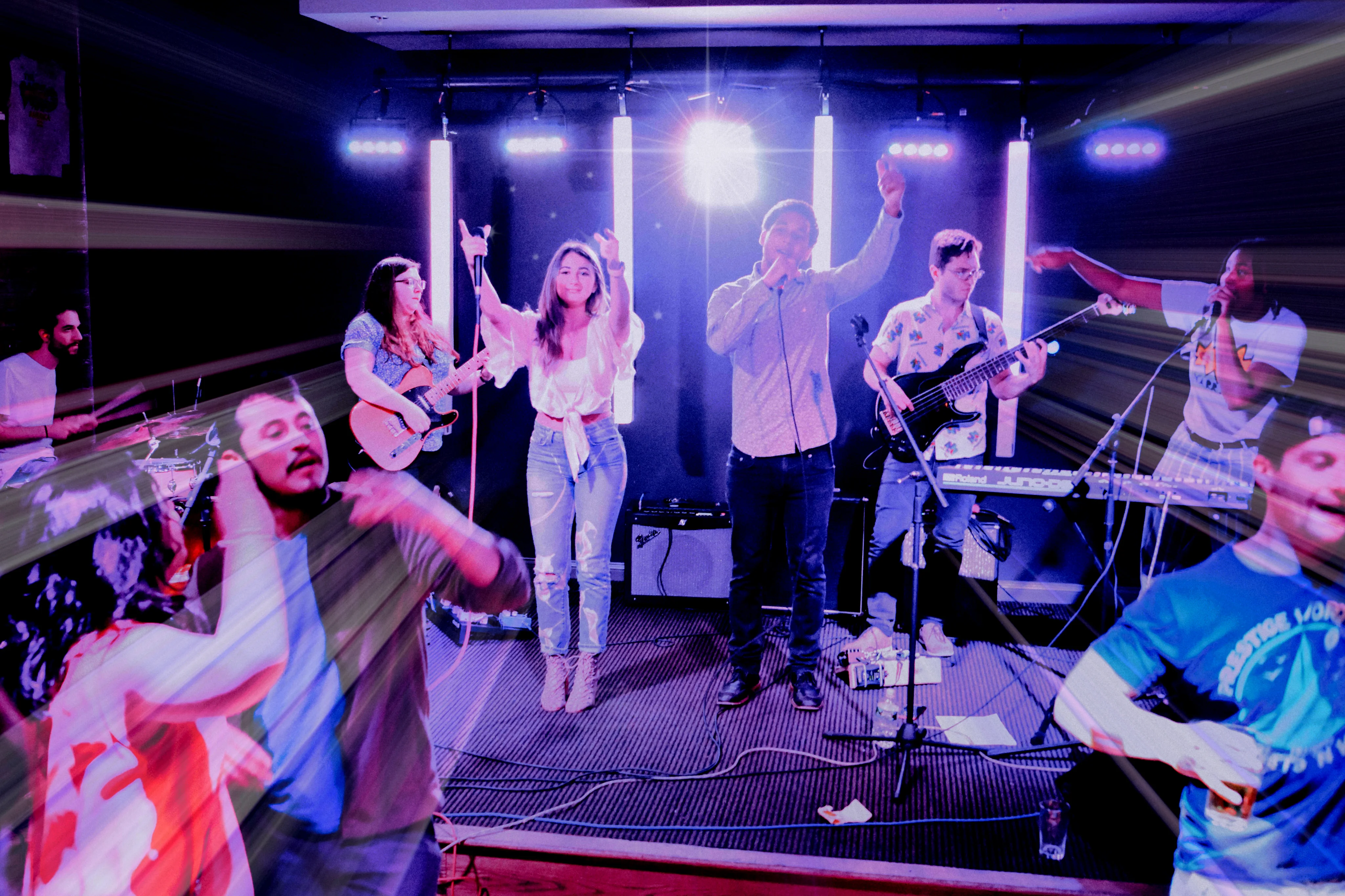 Live band performing on stage with vibrant lighting