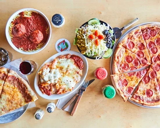 Italian feast with pepperoni pizza, spaghetti and meatballs, and fresh salad
